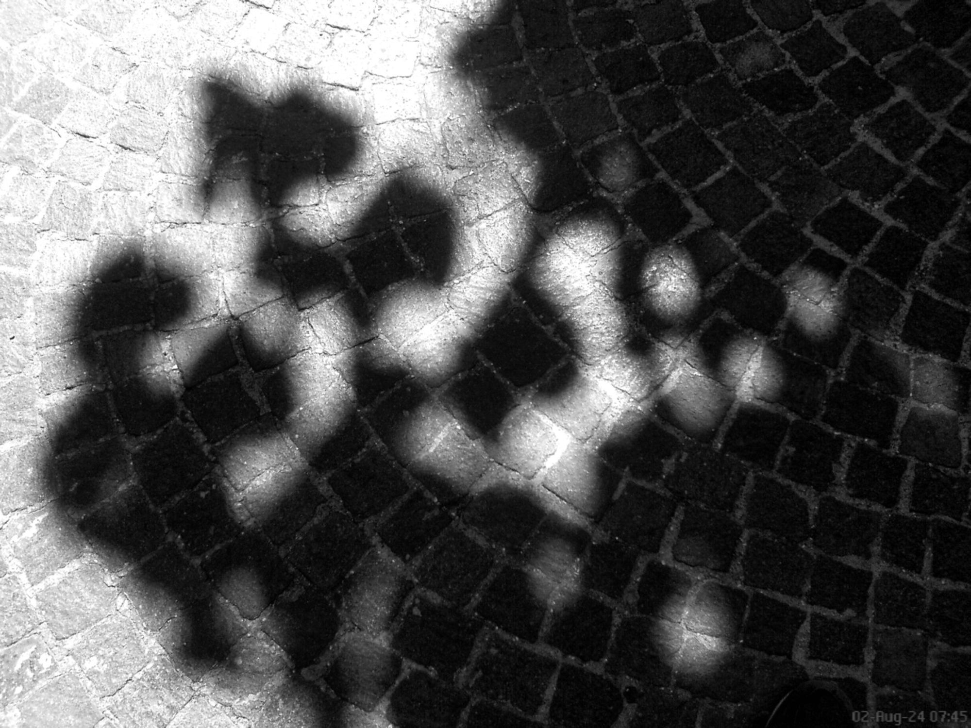 The streets of Rome - high-contrast light and shadow monochrome based on a photo from a 2006 Sony Ericsson W810i cell phone