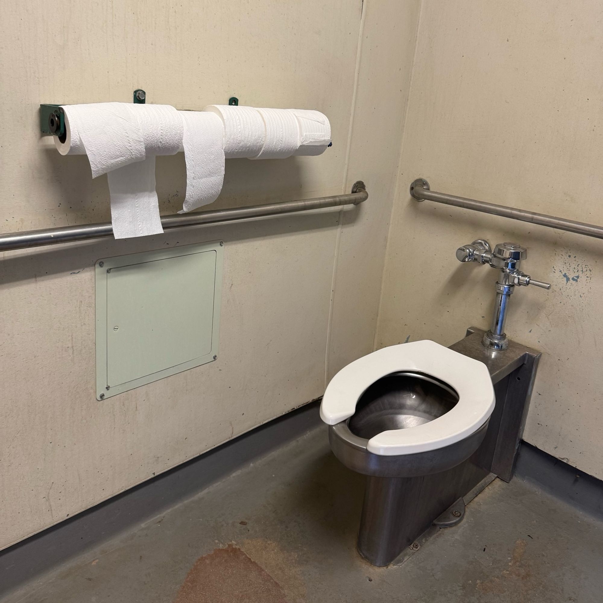 Public bathroom with no fewer than 6 rolls of toilet paper available