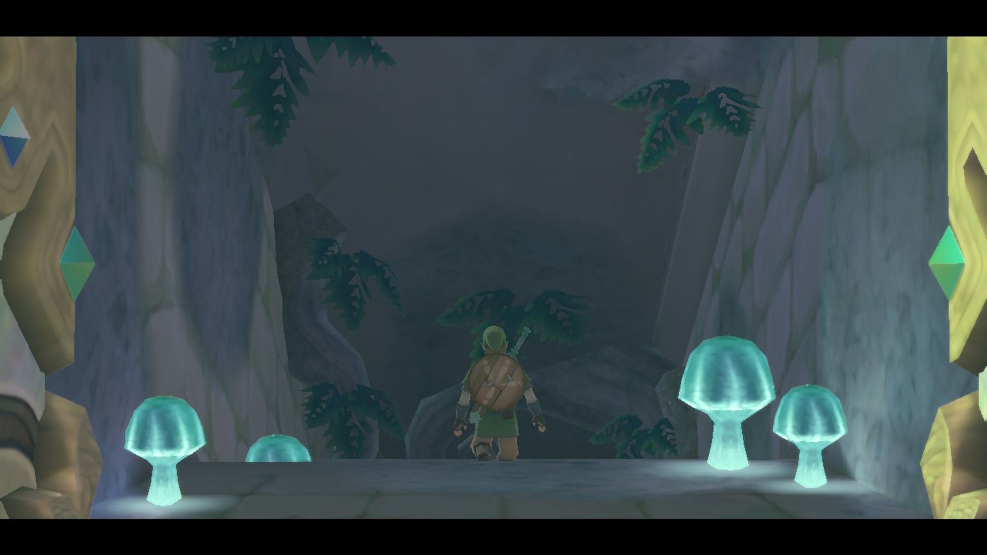 Screenshot from the game Skyward Sword HD of the entrance to the Skyview Temple. Large blue, glowing mushrooms are on each side and ferns are growing from the ceiling. In the centre, Link is descending downwards into the temple.