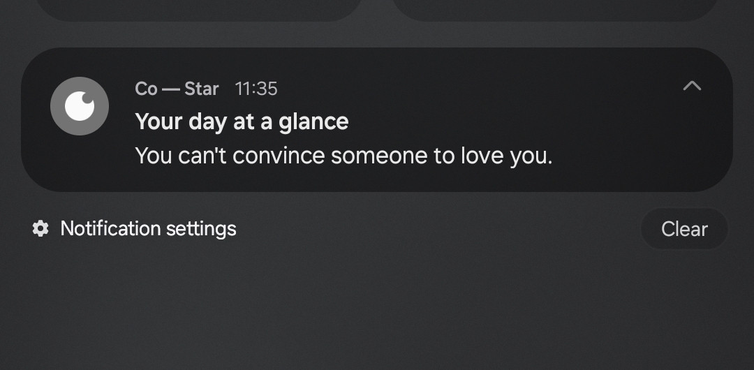 The image shows a notification from the Co-Star astrology app, with the message: "Your day at a glance - You can't convince someone to love you."