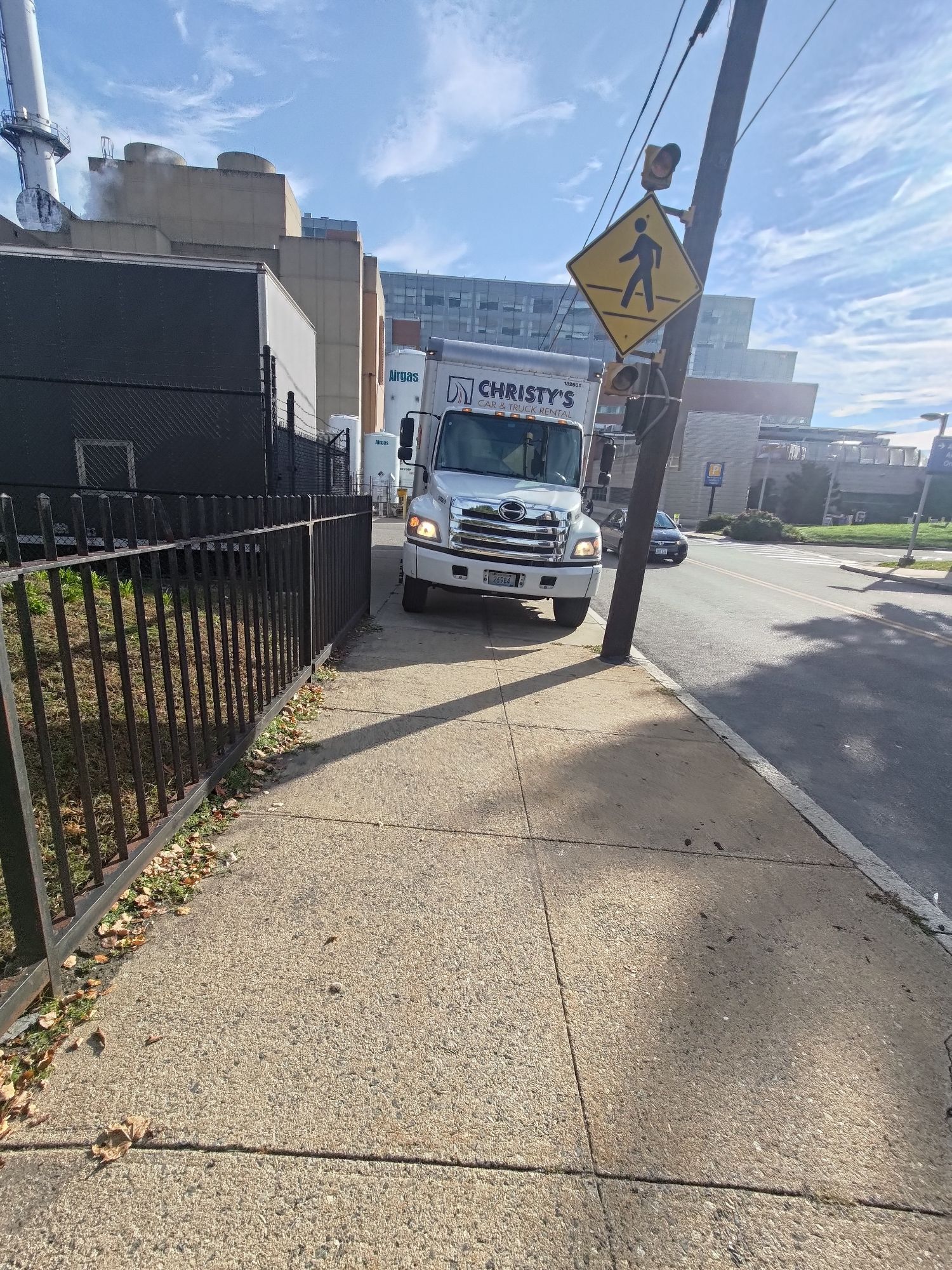 A large truck obstructing the sidewalk within a hospital complex