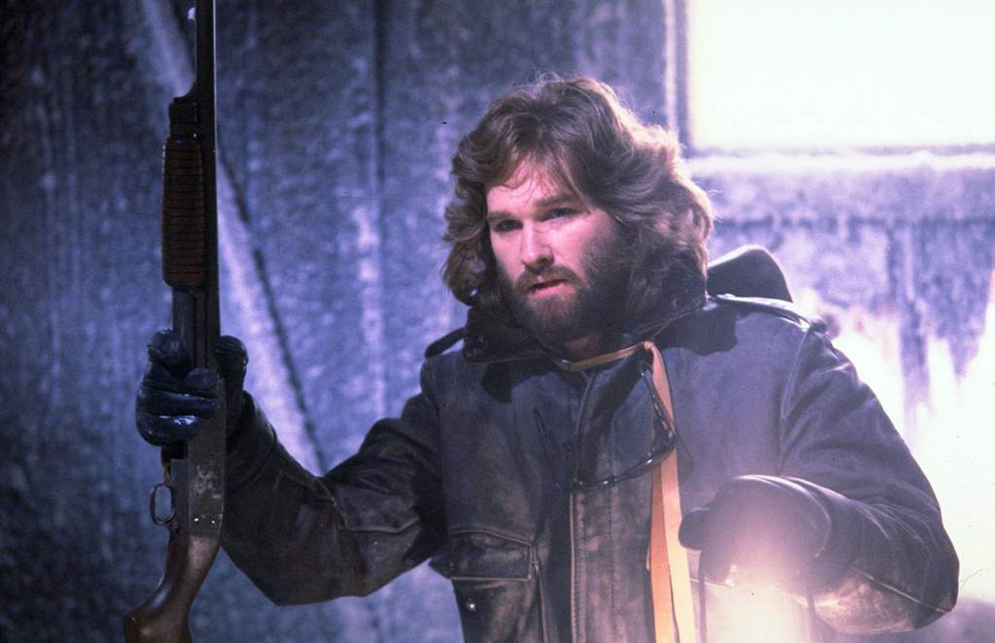 R.J. MacReady brandishing a shotgun and lantern.