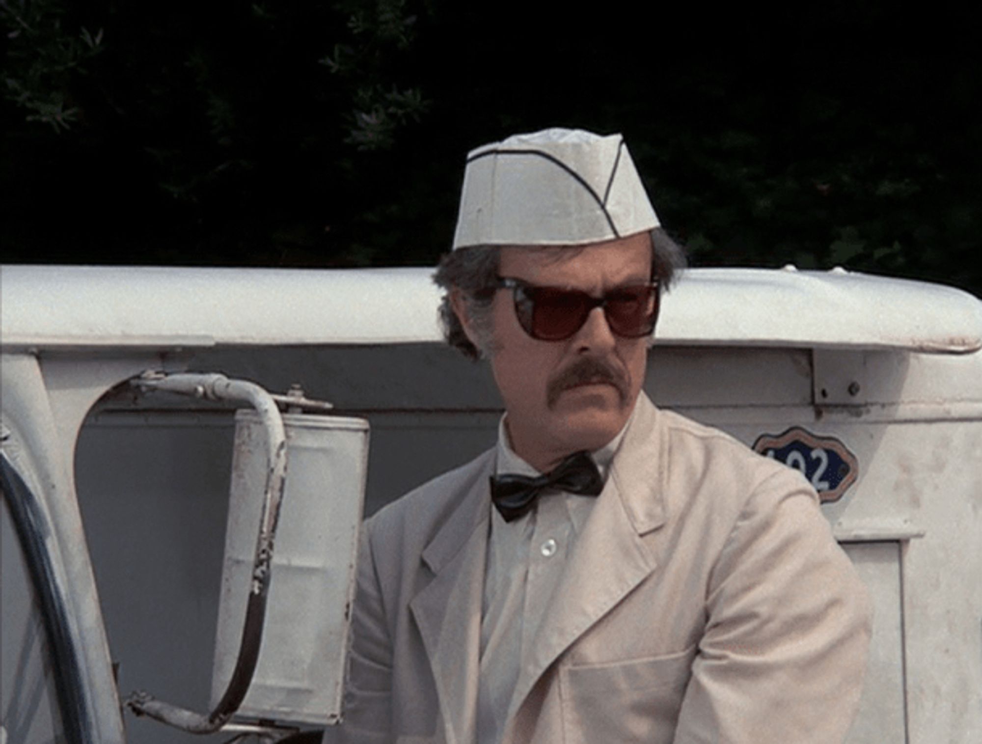 Robert Culp, with a cool mustache and sunglasses to go with his milkman uniform (white shirt, white jacket, little white hat) stepping out of his white milk delivery van and looking like he's up to no good (which is in fact what he's up to)