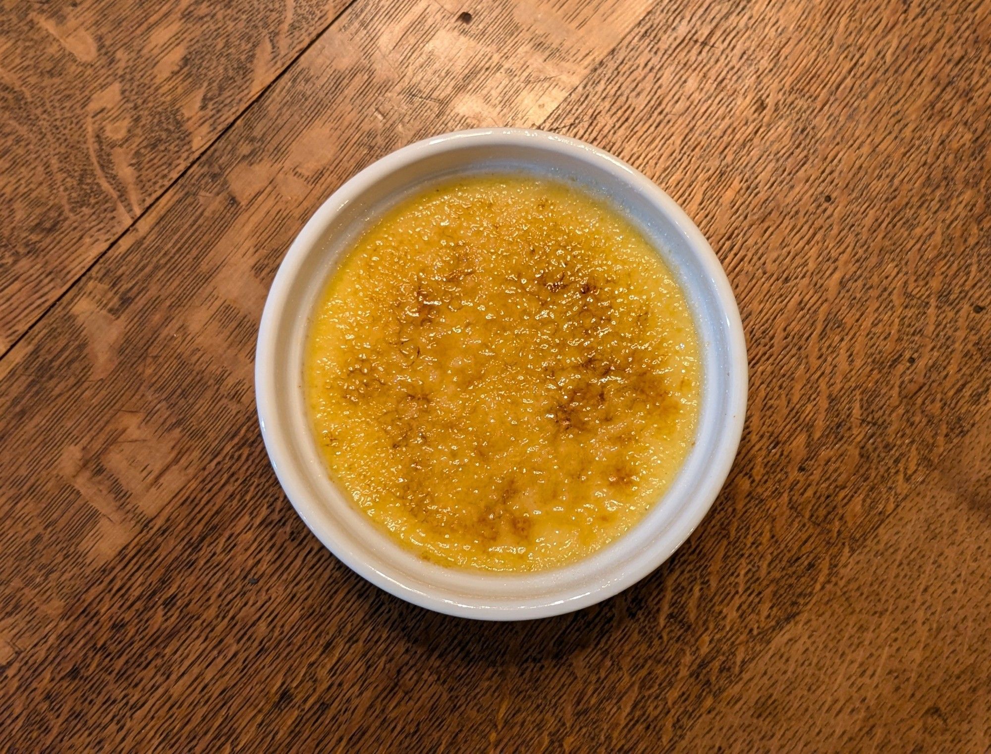 A creme brulee in a small ramekin