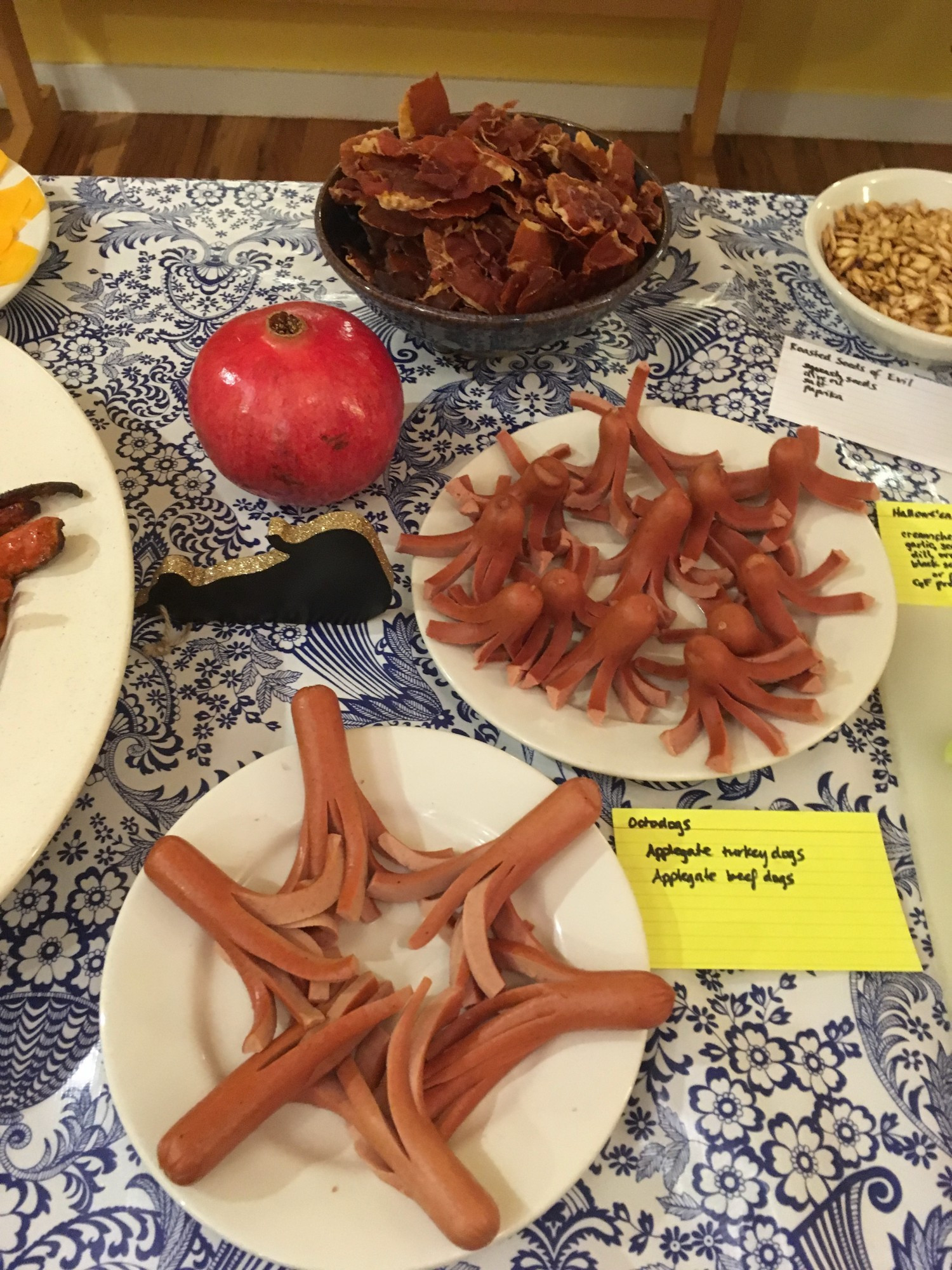 "Octodogs" (hot dogs cut into tentacle shapes); "seeds of evil" (roasted pumpkin seeds); an unlabeled bowl of something that looks like shed skin (probably broiled ham slices?).