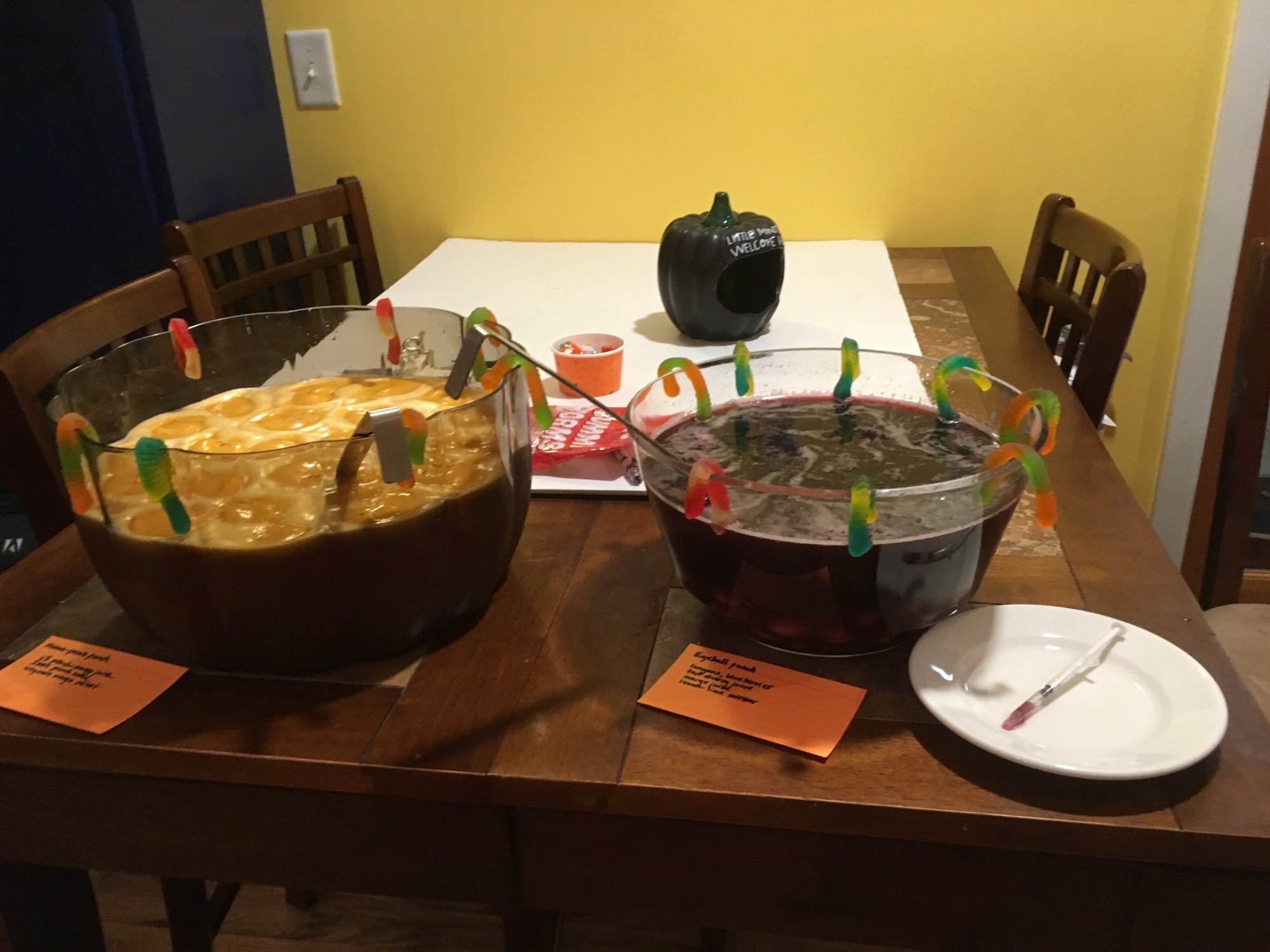 Punchbowls with beverages of vaguely threatening colors, draped in gummy worms and snakes.