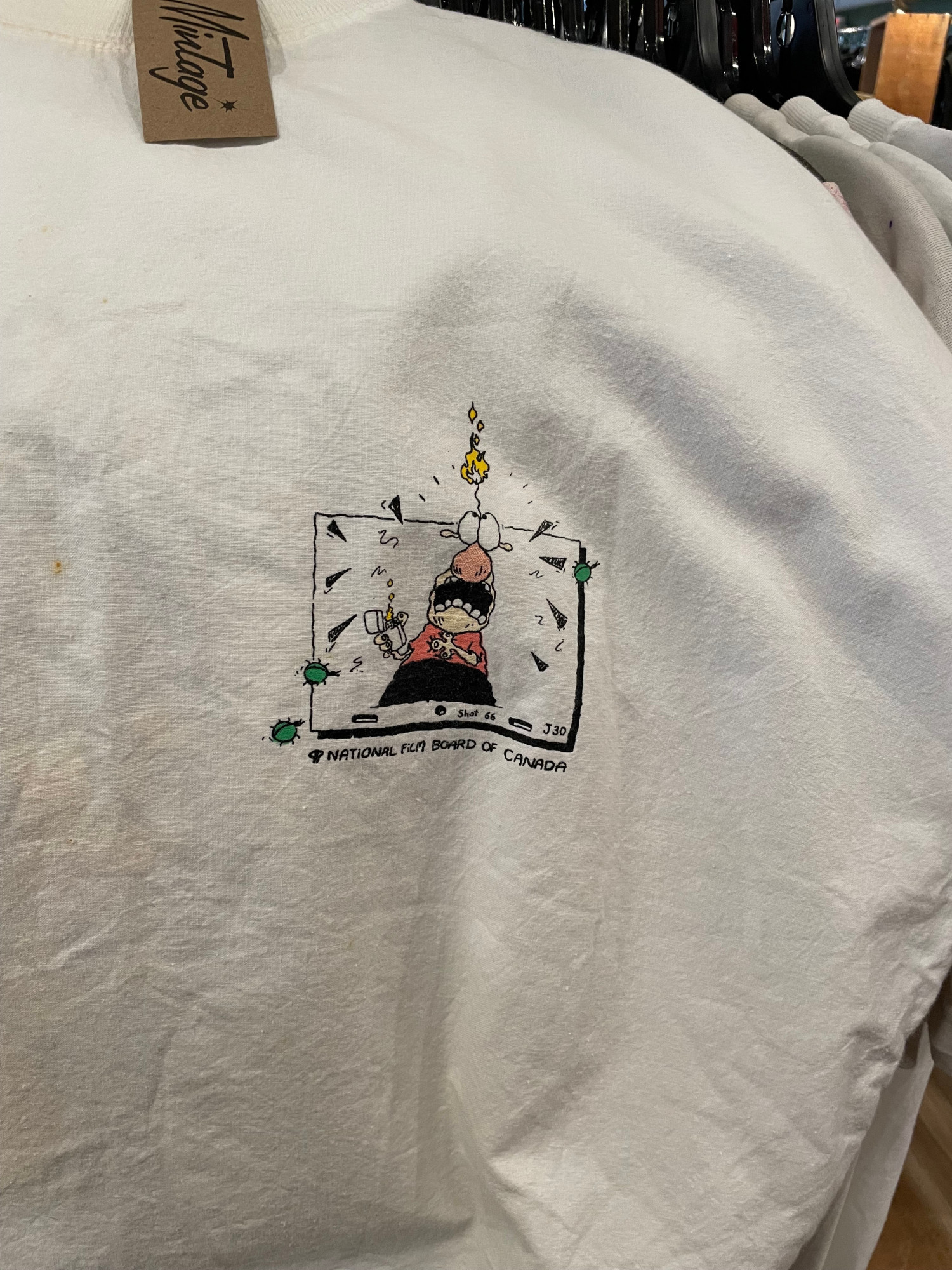 The front of the same shirt, showing a small illustration of a character from the short on an animation cel. The text underneath reads "National Film Board of Canada."