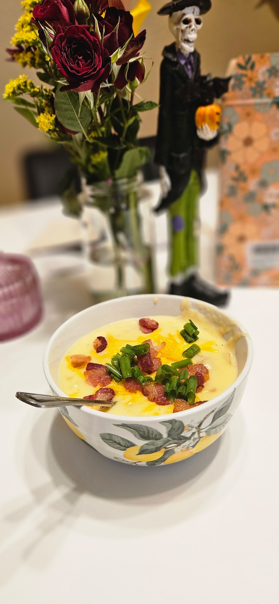 Photo of potato soup (this guy in the background, also flowers)