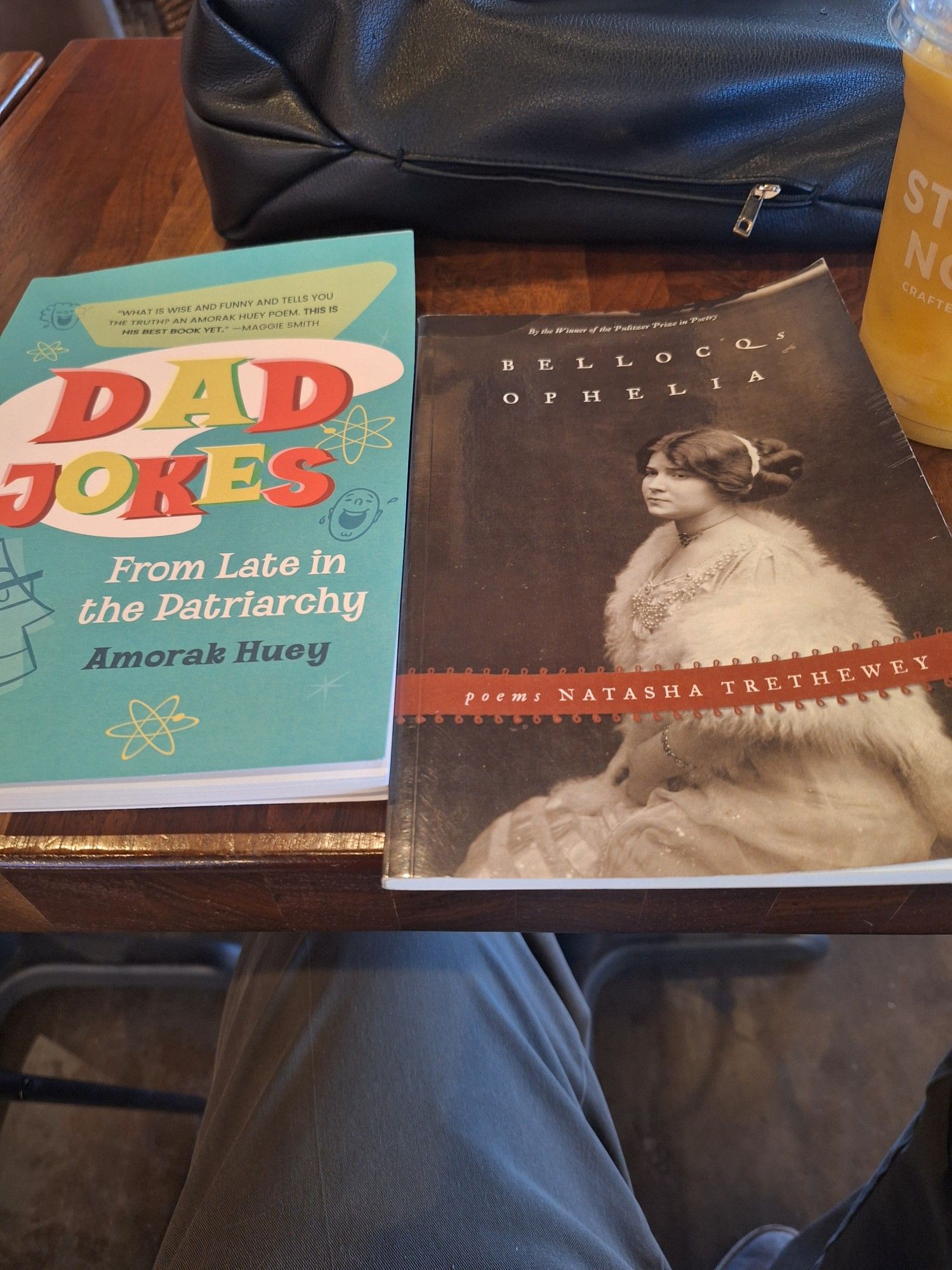 Two books on a table. Dad Jokes from Late in the Patriarchy by Amorak Huey. Bellocq's Ophelia by Natasha Trethewey.