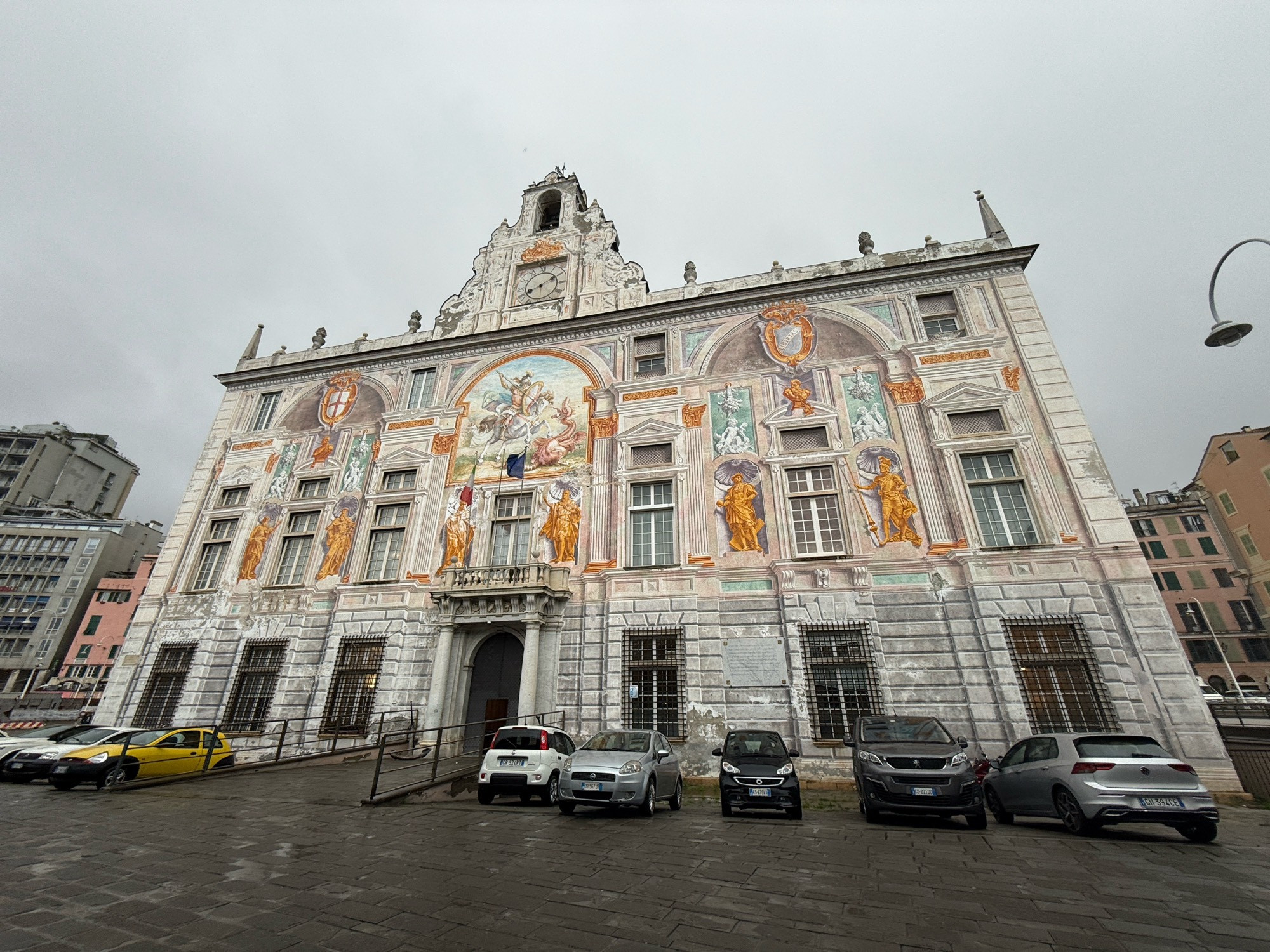 The Palazzo San Giorgio in Genoa, an ornate mural-covered building. The weather is still lousy.