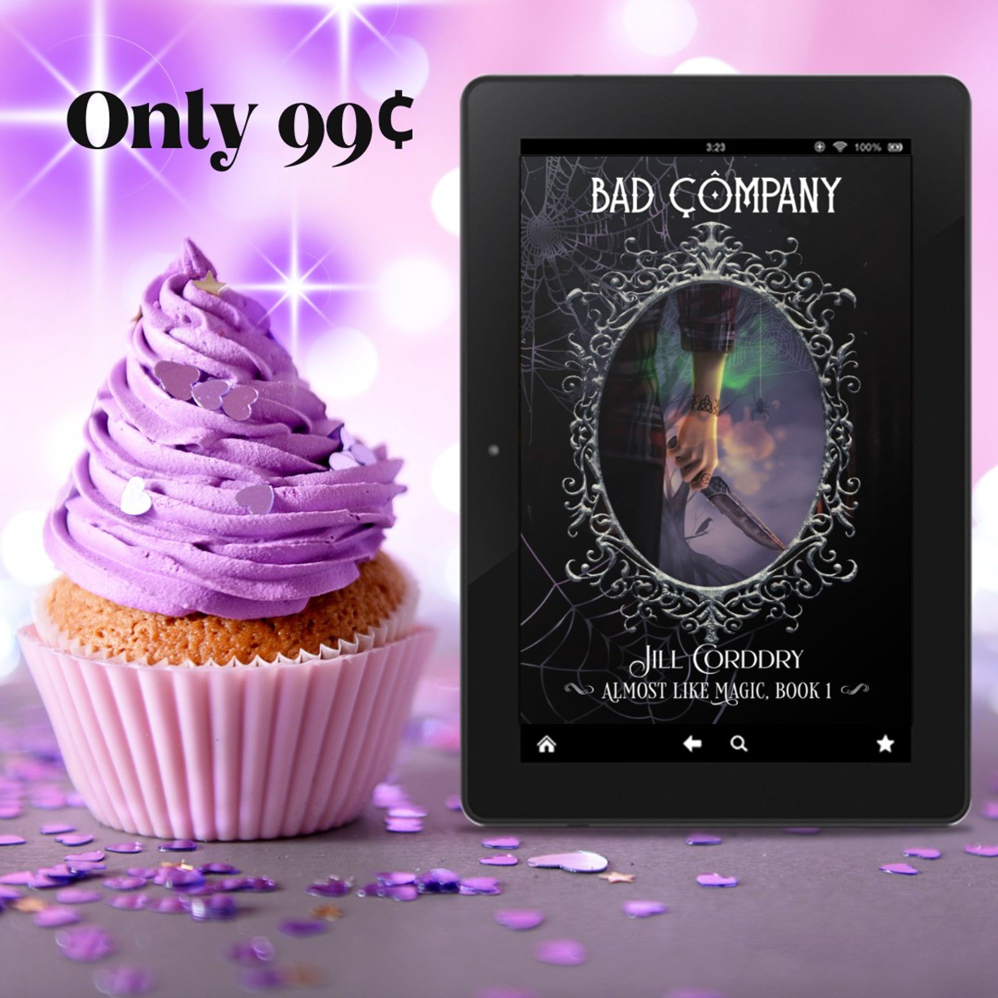 Image is a birthday celebration! The background is pale purple with bright glittery white flares. In the forefront is a vanilla cupcake in a purple cupcake paper and with tall purple frosting...both match the background. Purple heart confetti is strewn about the darker purple table. To the right of the cupcake is an e-reader with the cover of Bad Company: Almost Like Magic, book 1, by Jill Corddry (hi! that's me!) In bold black curly font in the upper left corner reads: Only 99¢