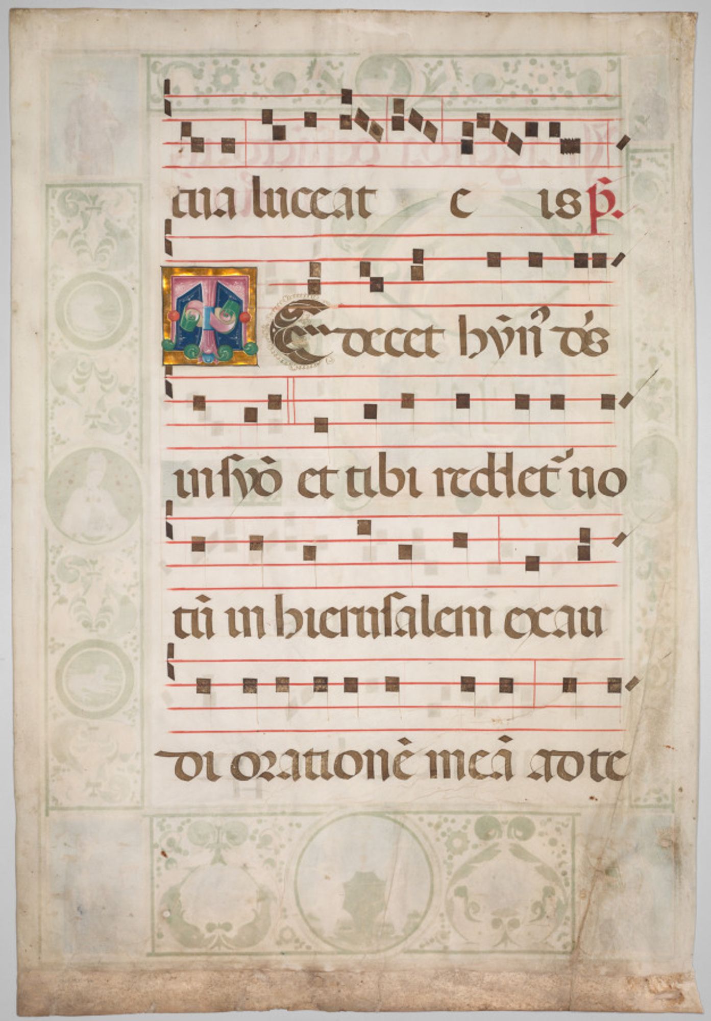 This leaf was excised from a volume of a large set of choral books known to have been commissioned by Bartolomeo delle Rovere for Ferrara Cathedral. Delle Rovere, nephew of Pope Sixtus IV, was the Bishop of Ferrara from 1474 to 1494 and his arms appear in the rondel at the bottom of the page-a shield bearing an oak tree (rovere in Italian) surmounted by a patriarchal cross, the symbol of his rank and authority. Payment records indicate that Argenta worked on the choir books for Ferrara Cathedral from 1478 to 1486. The large historiated initial R dominates the extensive decoration including a realistically painted scene in which a priest (center) surrounded by acolytes stands over the body of the deceased as he reads the Office of the Dead. The ceremony takes place within a vaulted chapel that recedes in space to create the illusion of perspective. This leaf and the one to the right are from the same set of choir books.