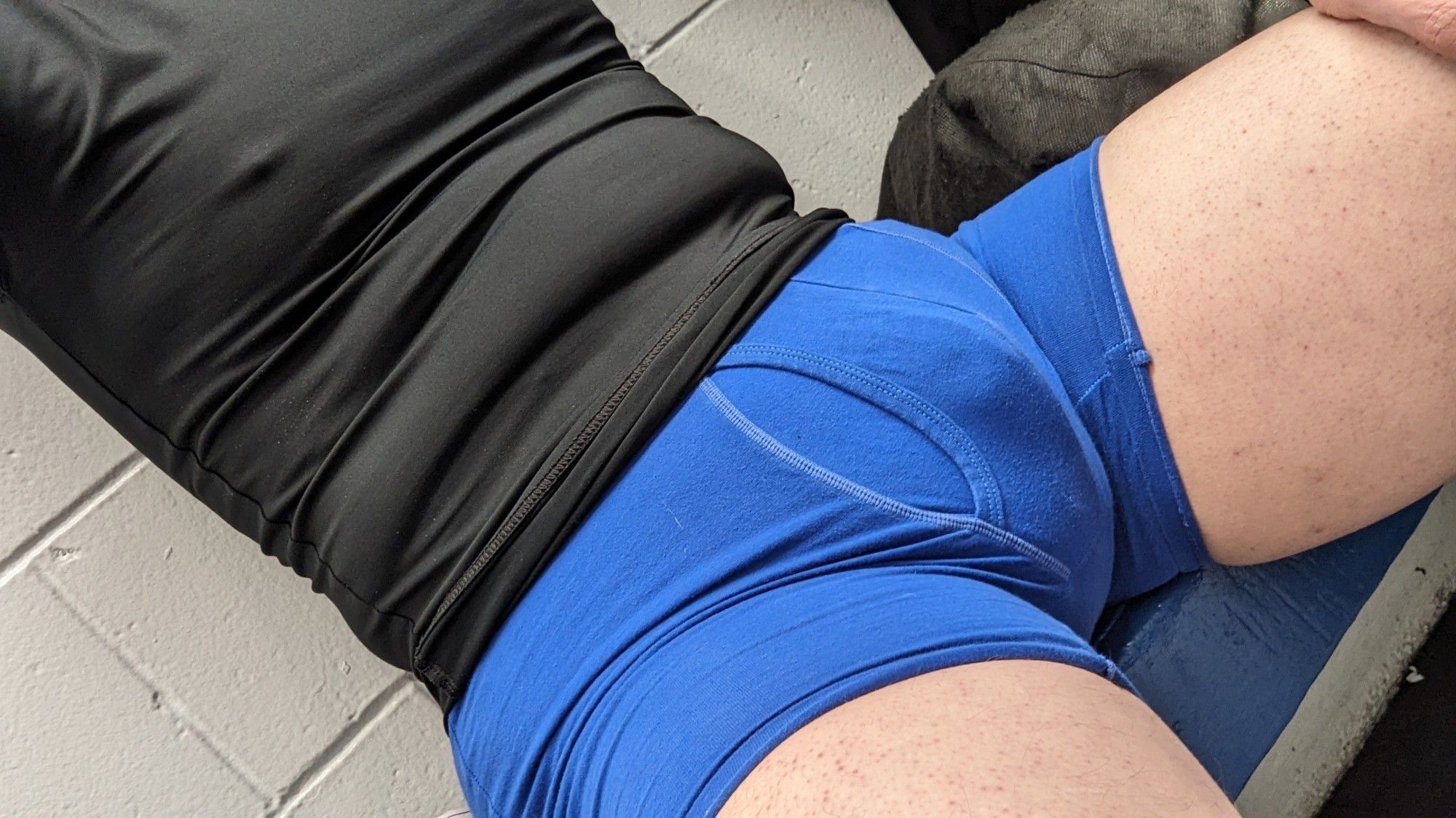 Augie sits before you, wearing fresh new royal blue boxer briefs and a black compression shirt. Augie's little stomach rolls can be seen, as well as his pecs. It's rather cold and nipples are popping