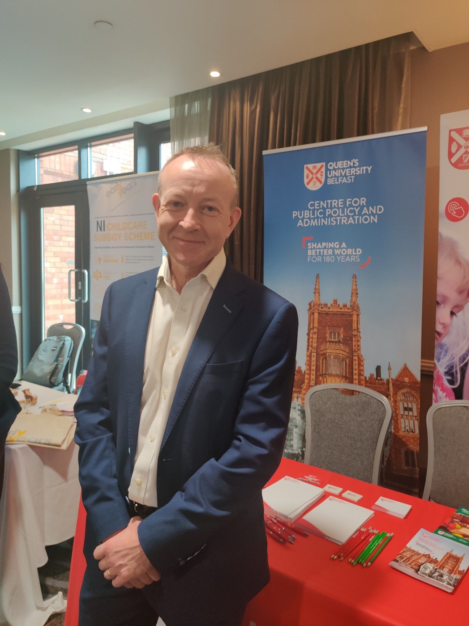 Our co-director Peter Gilleece standing in front of the CPPA stand at the SDLP conference