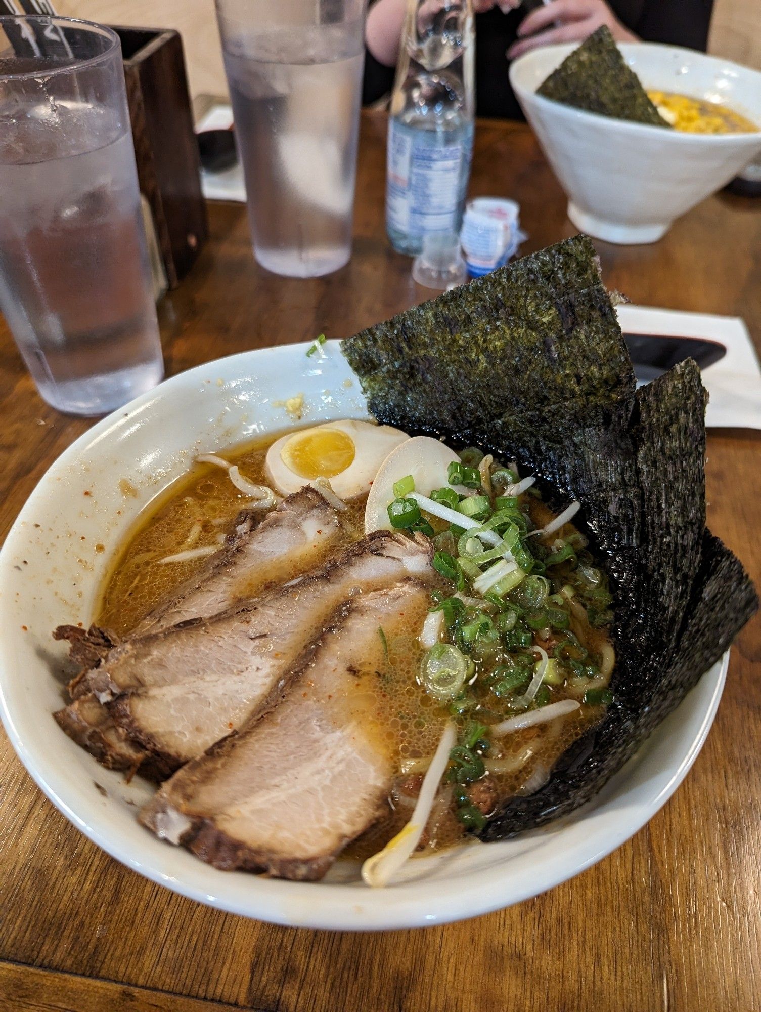 Bowl of ramen with seaweed, shallots, pork belly, soy sprouts, egg