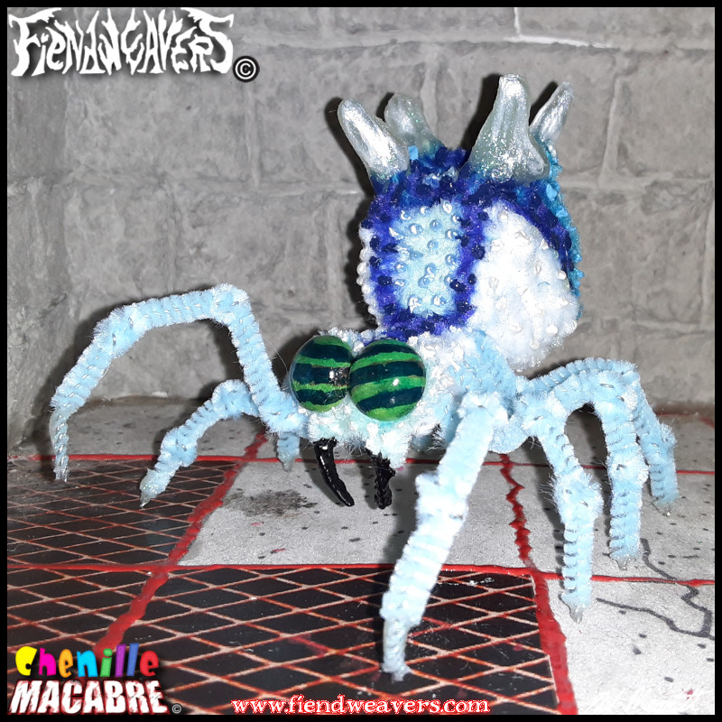 A pipe cleaner figure I built of an ice spider I call the Frost Widow. She has green horsefly eyes, dark to light blue coloration, and icicles growing from her abdomen.