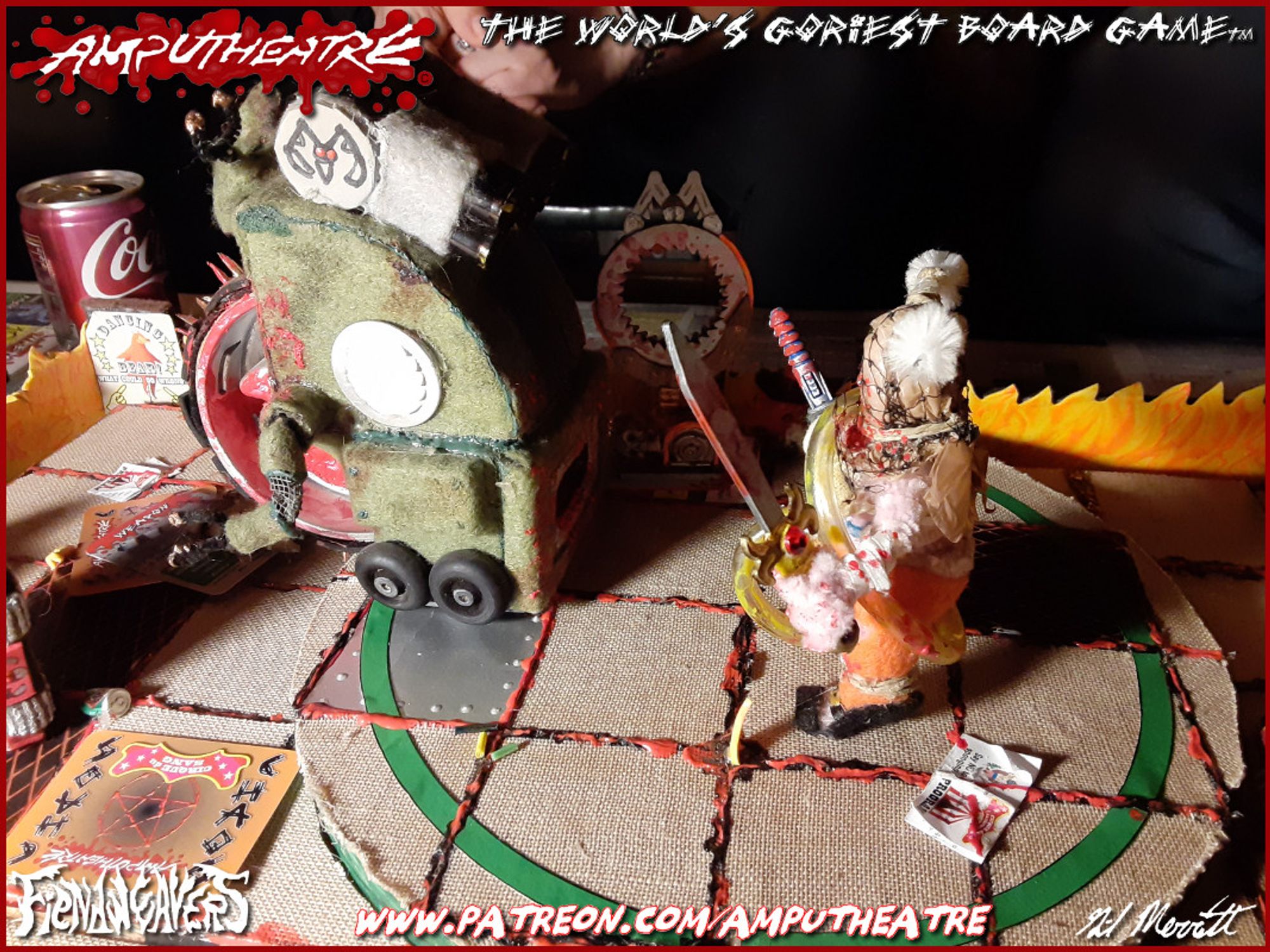 A photo from last night's session of AMPUTHEATRE, The World's Goriest Board Game. A giant green roller wheel robot is being chased by a large woman with a sword.