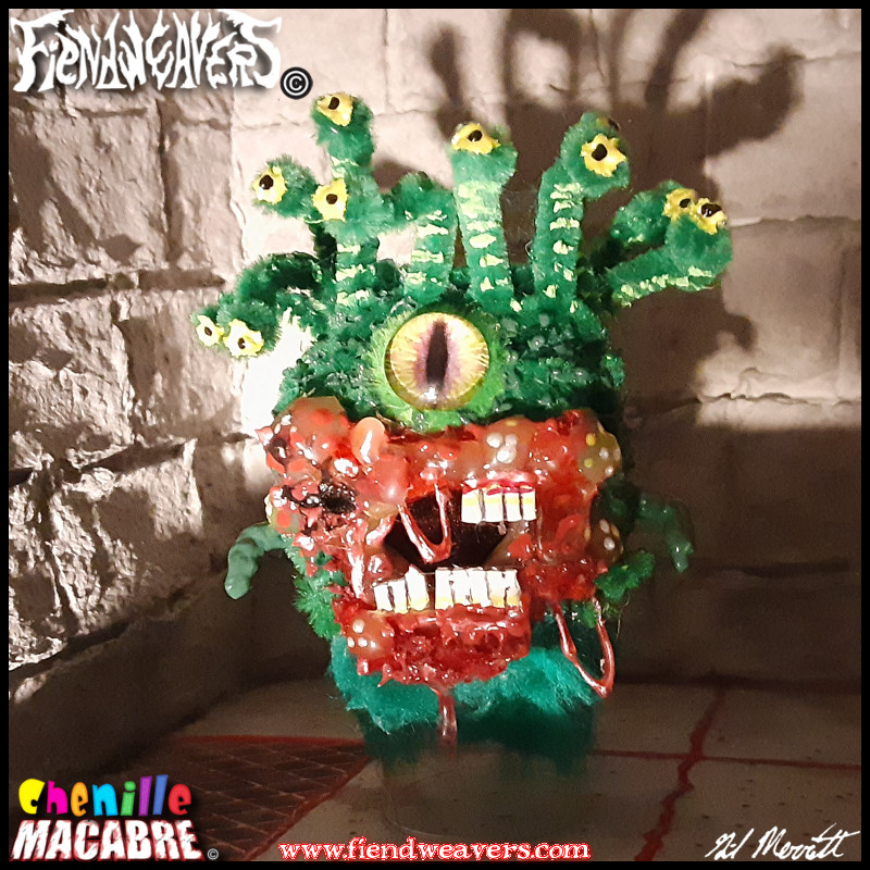 A pipe cleaner figure i built of a Beholder from Dungeons and Dragons. It is a green floating sphere with a single eye, ten smaller eyes protruding from stalks, and a maw covered and surrounded by boils and sores.