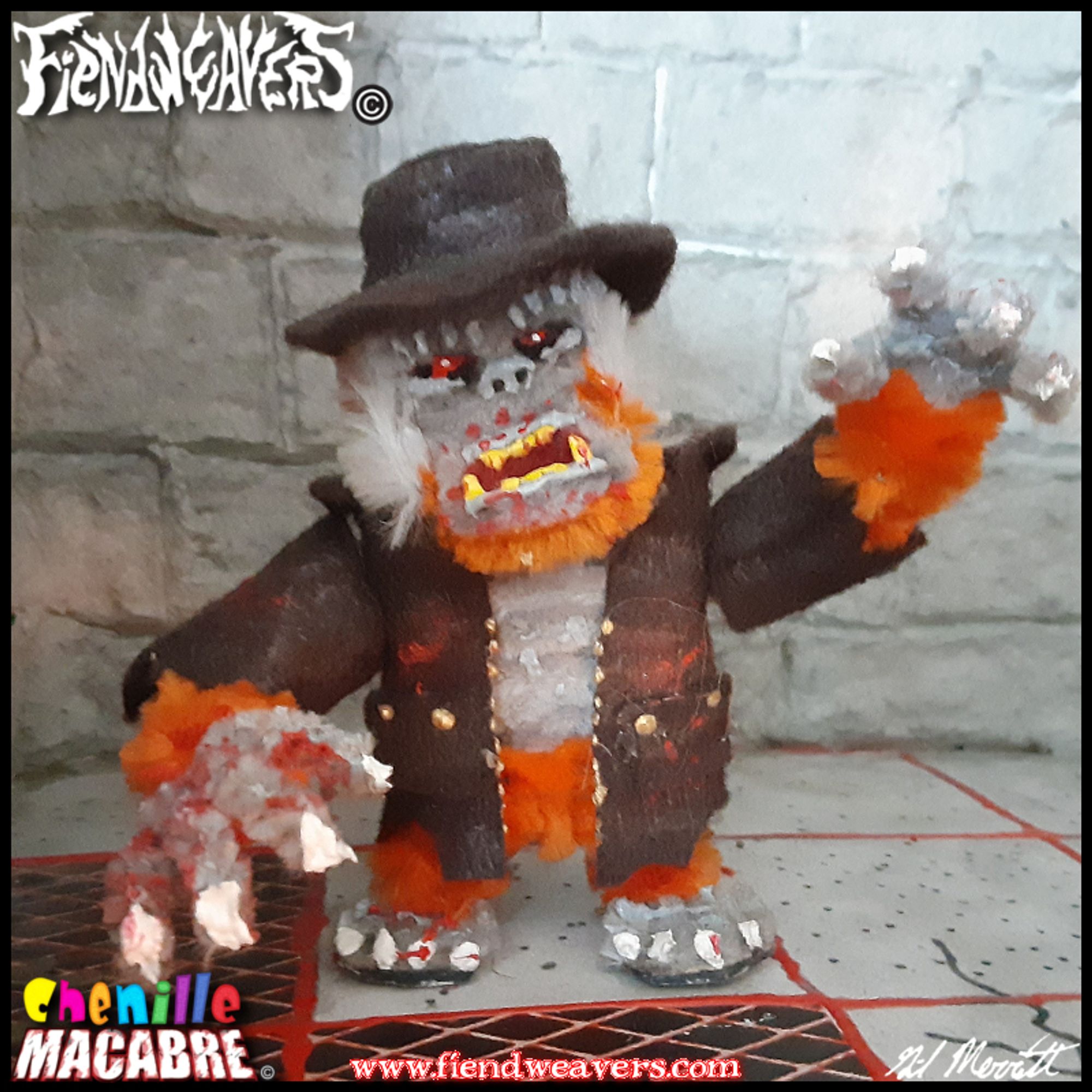 A pipe cleaner figure I built of Kongor, a playable fighter in my tabletop horror fighting game AMPUTHEATRE. Kongor is a murderous silverback gorilla in a trenchcoat, styled after the ape in Edgar Allen Poe's THE MURDERS IN THE RUE MORGUE. This figure of Kongor is patterned after the gross ape Chaos from the video game PRIMAL RAGE; he has grey skin and orange fur. It stands 3" (7.62 cm) high, and its head and arms come off for AMPUTHEATRE combat.