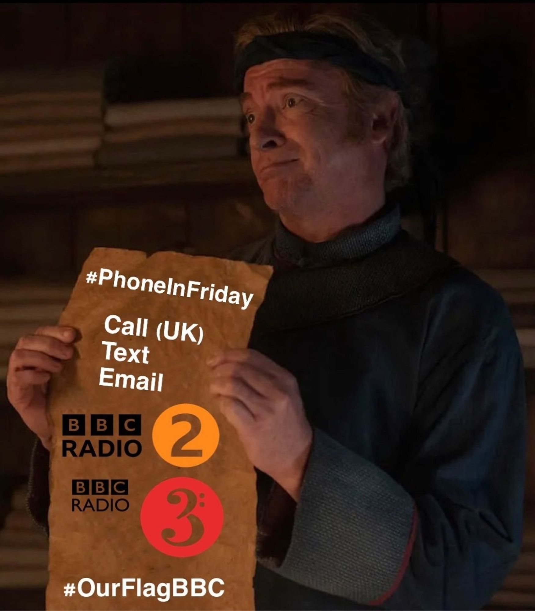 Stede is holding up a parchment displaying the BBC Radio 2 and 3 logos and the text #phone in Friday call (UK) text email #OurFlagBBC