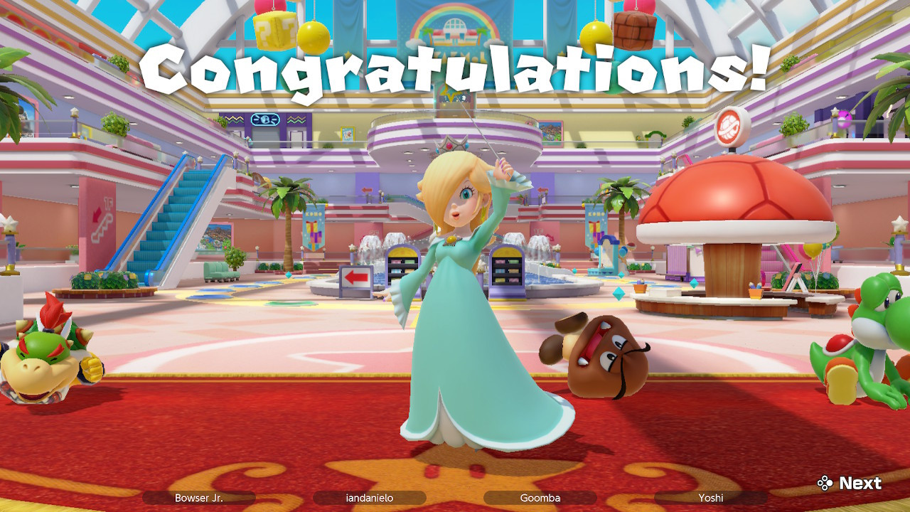 [Super Mario Party Jamboree] Rosalina wins (that's me!). She poses in the middle of the screen while the other player frown in the background. Text saying "Congratulations!" is at the top of the screen.