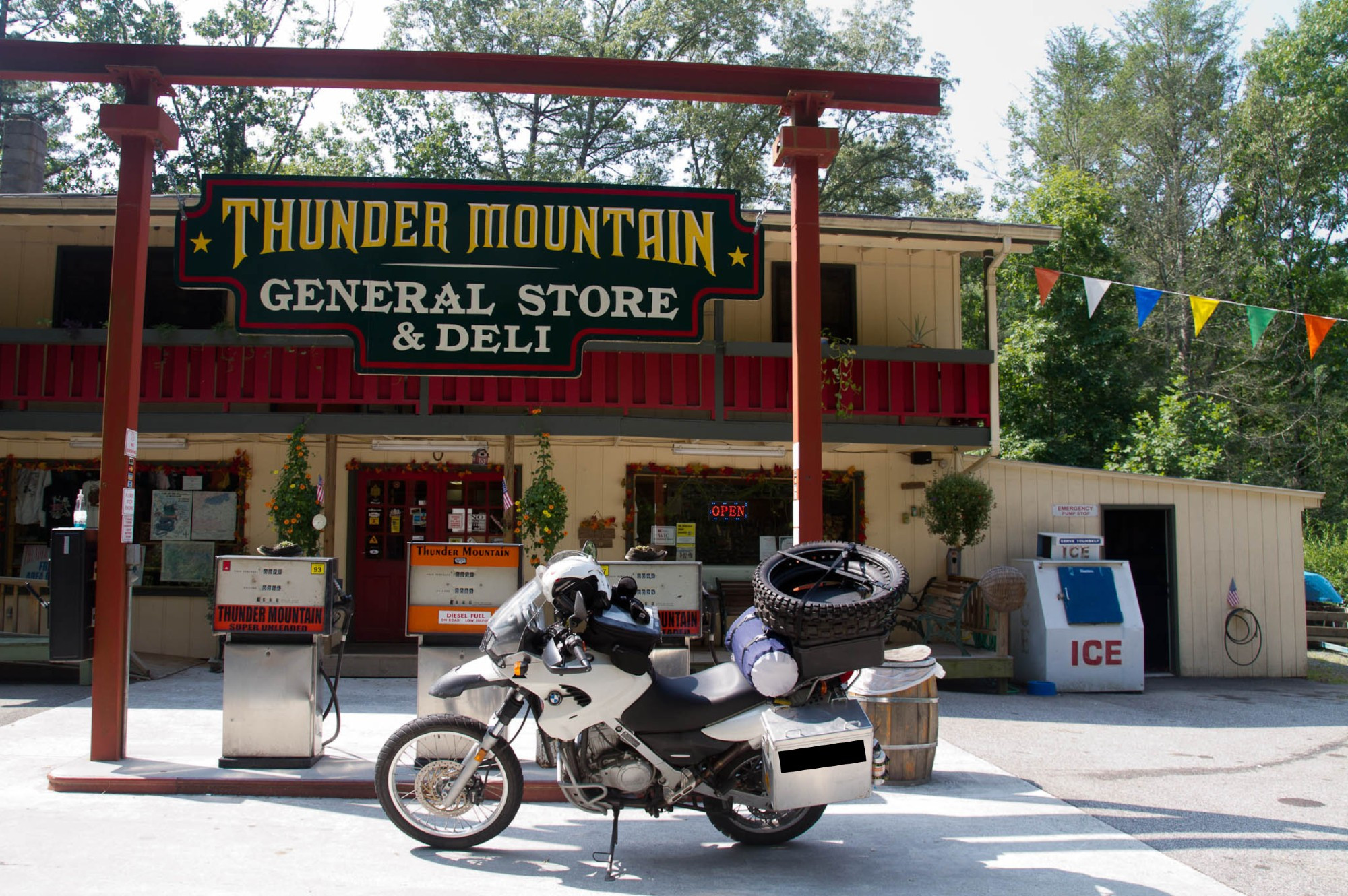 A white BMW F650GS Dakar, loaded with way too much crap, parked in front of the Thunder Mountain General Store & Deli, in NC.