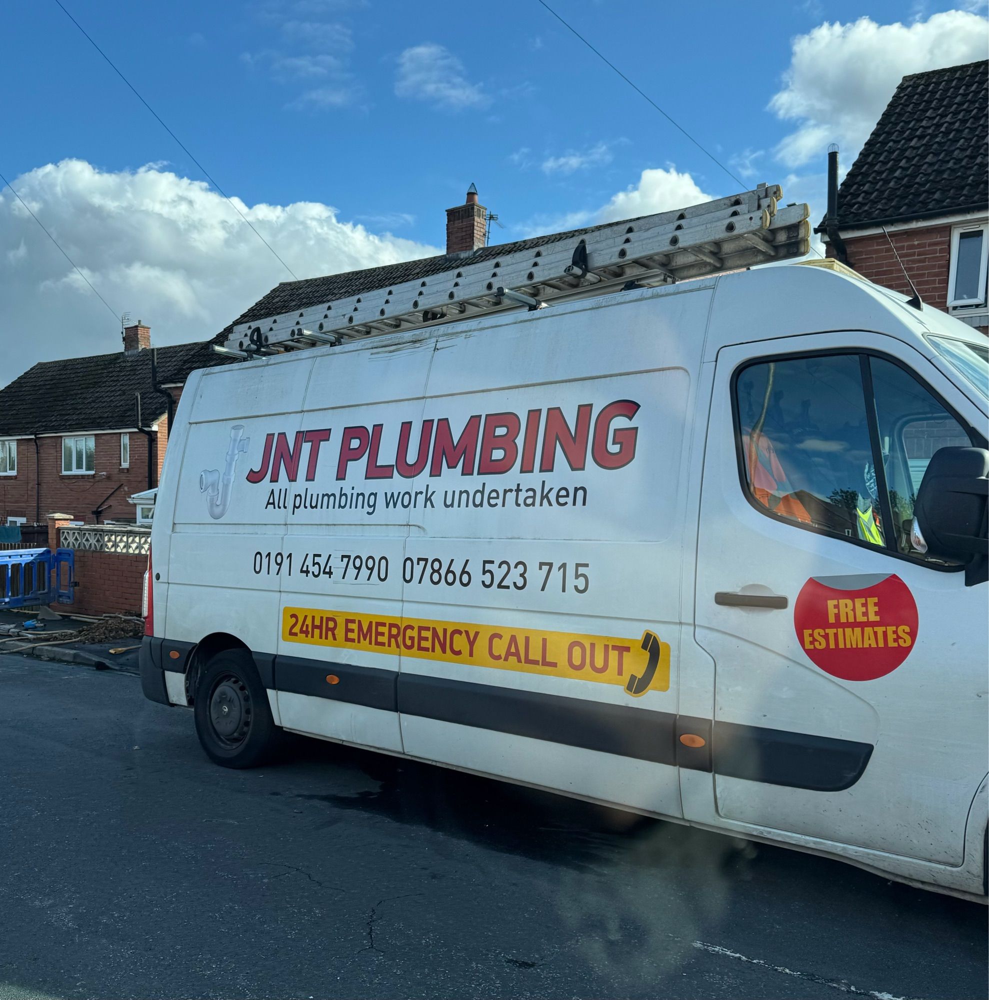 White van with ‘JNT Plumbing’ written on the side.