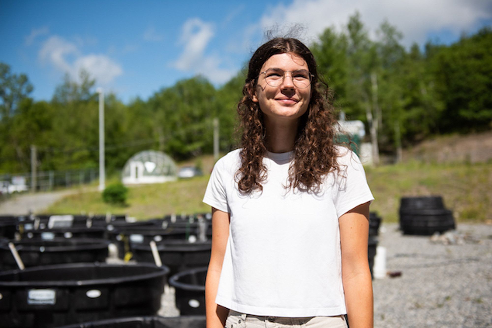 Photo of PhD candidate Emma Derrick with the Large Experimental Array of Ponds in the background. Photo credit: Alex Tran.