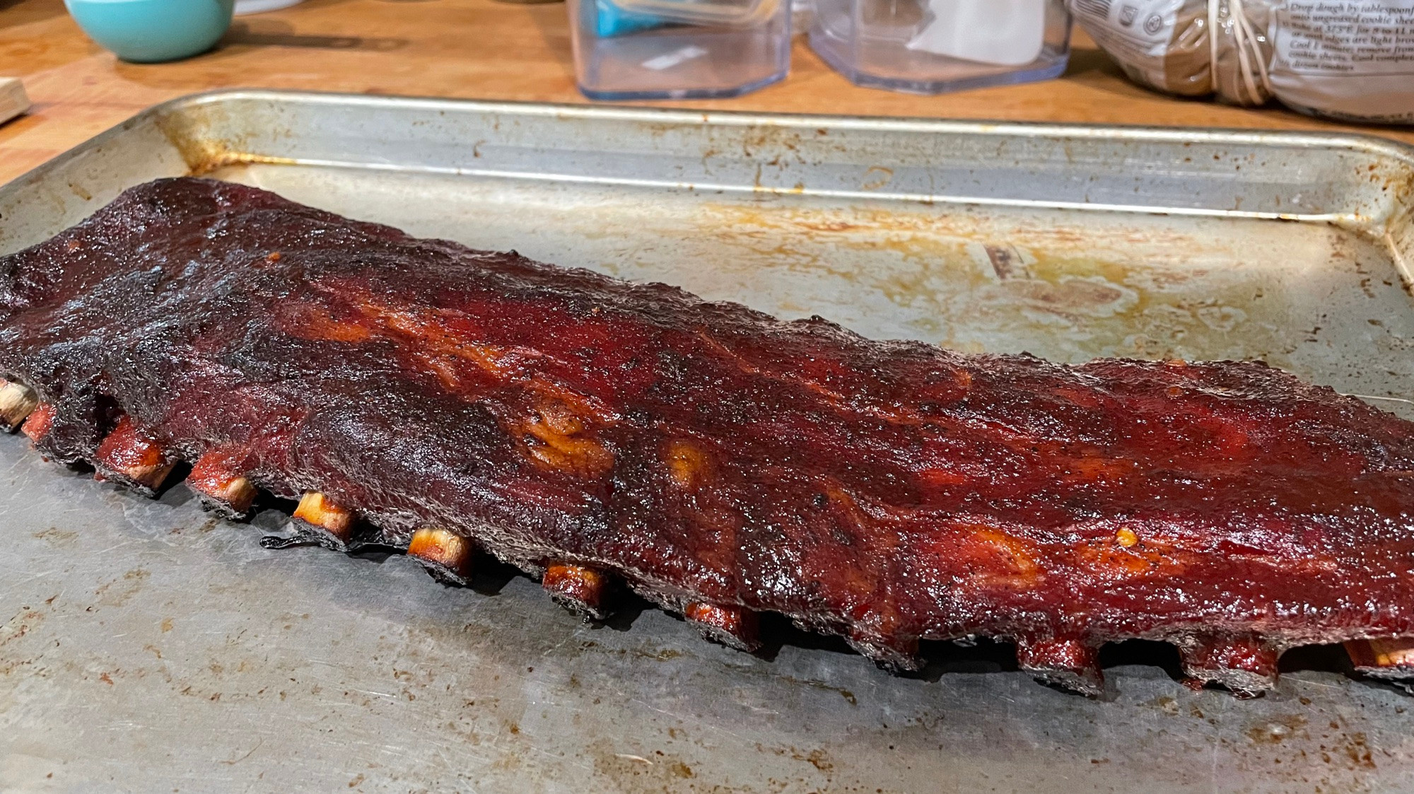 A full rack of ribs, rubbed with spices, smoked for 3 hours, and eventually topped with barbecue sauce.