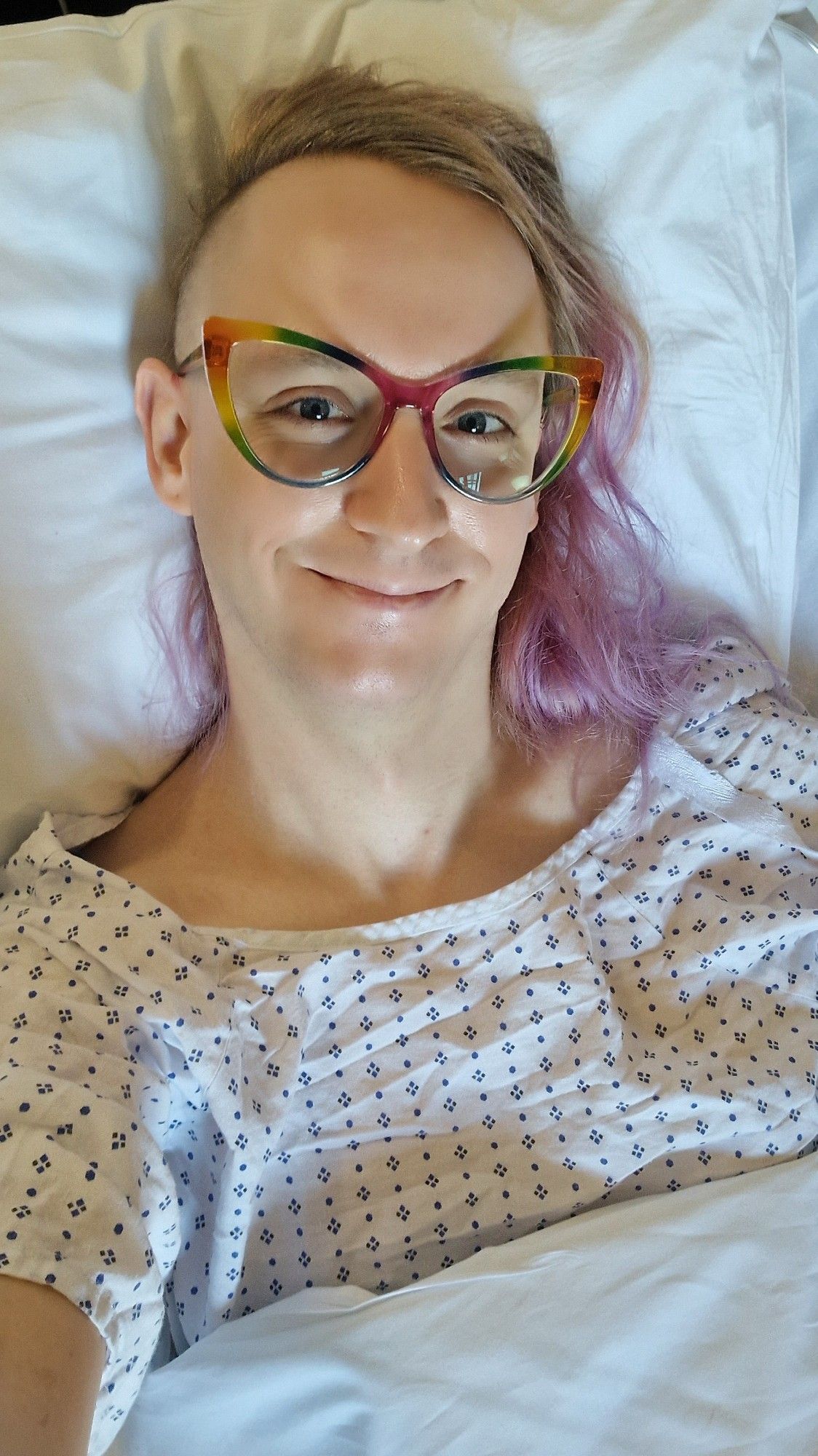 Selfie of me in a hospital bed, with a massive smile on my face