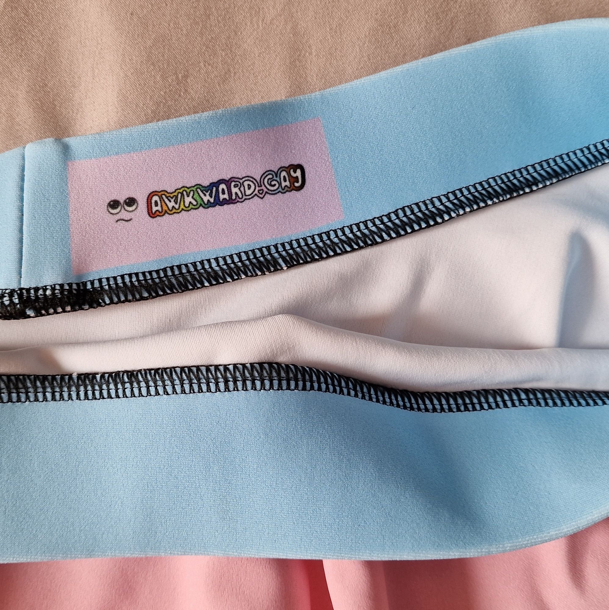 Closeup of my awkward.gay logo printed inside the waistband of the skirt