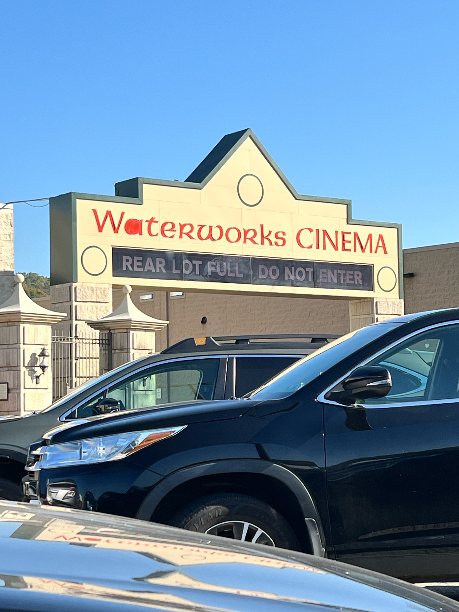 A strip mall sign at the Waterworks Cinema, has lettering underneath that can be lit up but is not now that says “REAR LOT FULL DO NOT ENTER” indicating there is a rear lot that could be full but is not now. I am 38, have lived here almost my whole life, and have never seen this sign ablaze. 