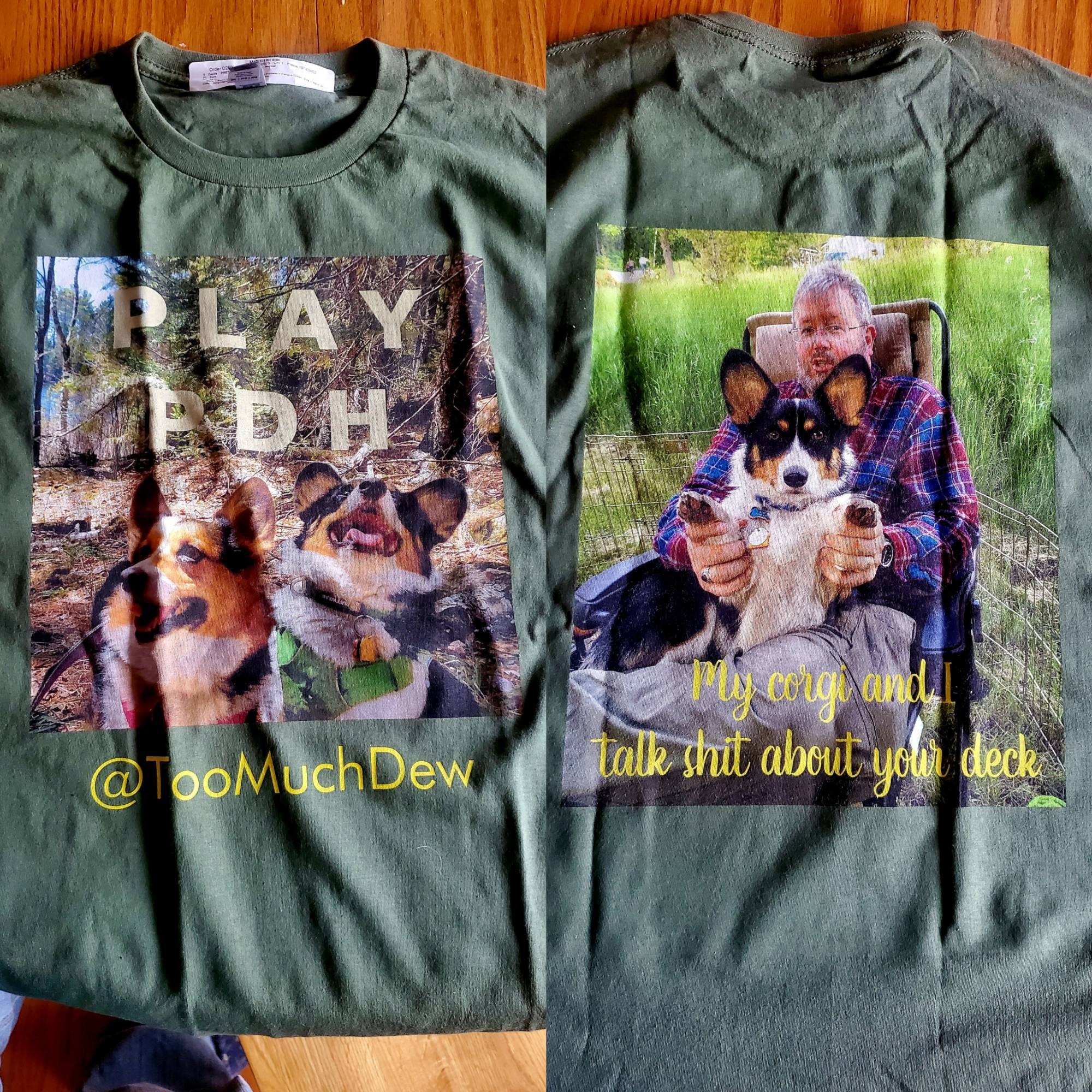 "PLAY PDH" t-shirt with @TooMuchDew and Pembroke Welsh Corgi siblings Freyja Frostypaws and Loki Laughinghund on the front. "My corgi and I talk s*** about your deck" on the back.