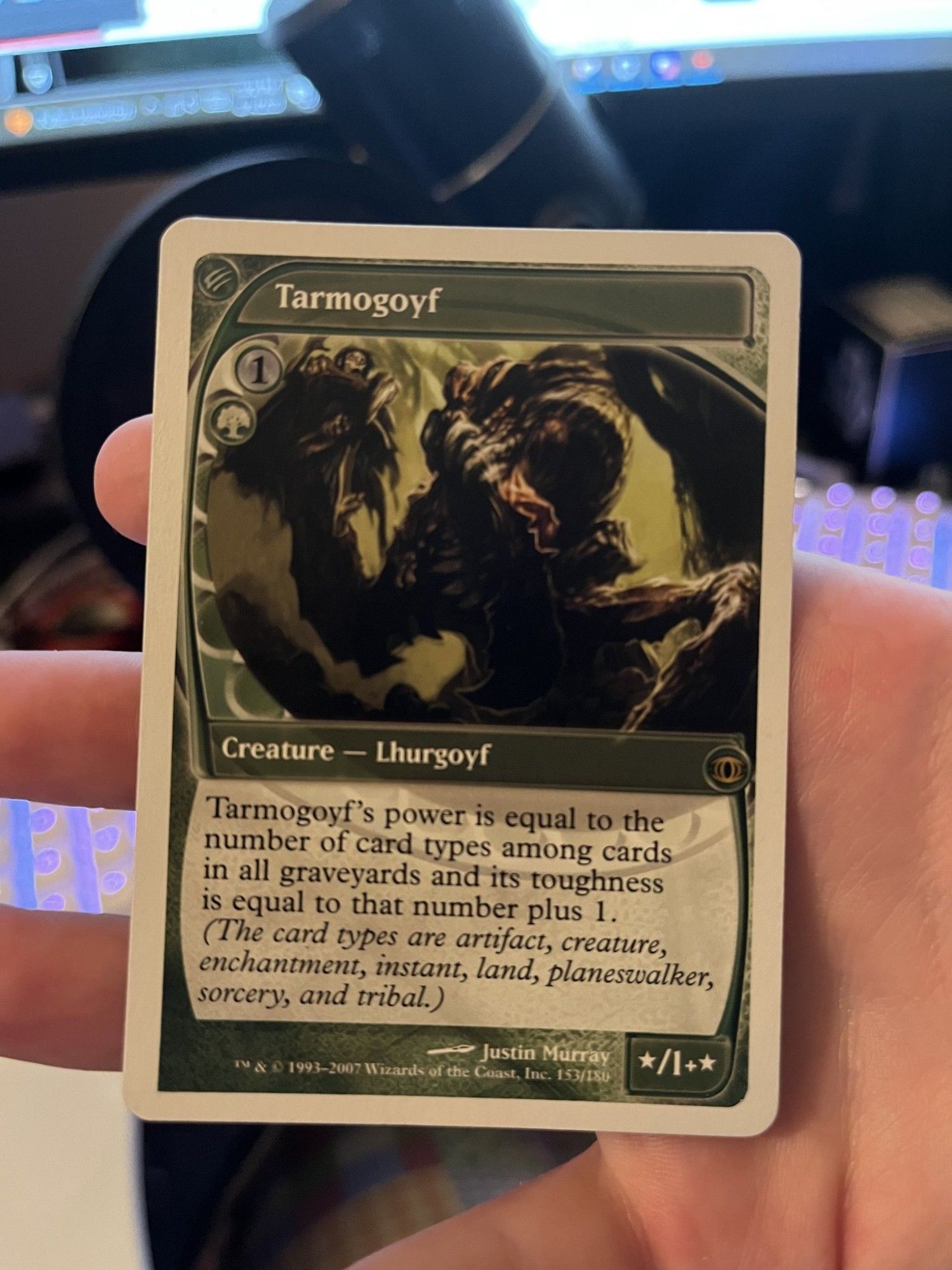 picture of a tarmogoyf from the magic the gathering set future sight, with a white border instead of a black one