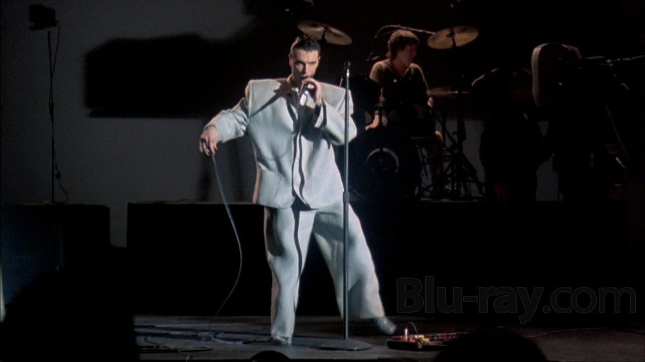 Talking Heads' David Byrne in his notorious big suit from STOP MAKING SENSE, not actually singing Psycho Killer