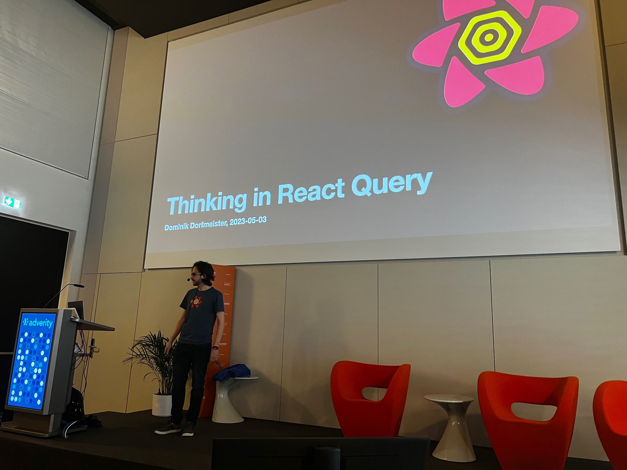 Me on stage, slide says: Thinking in React Query 