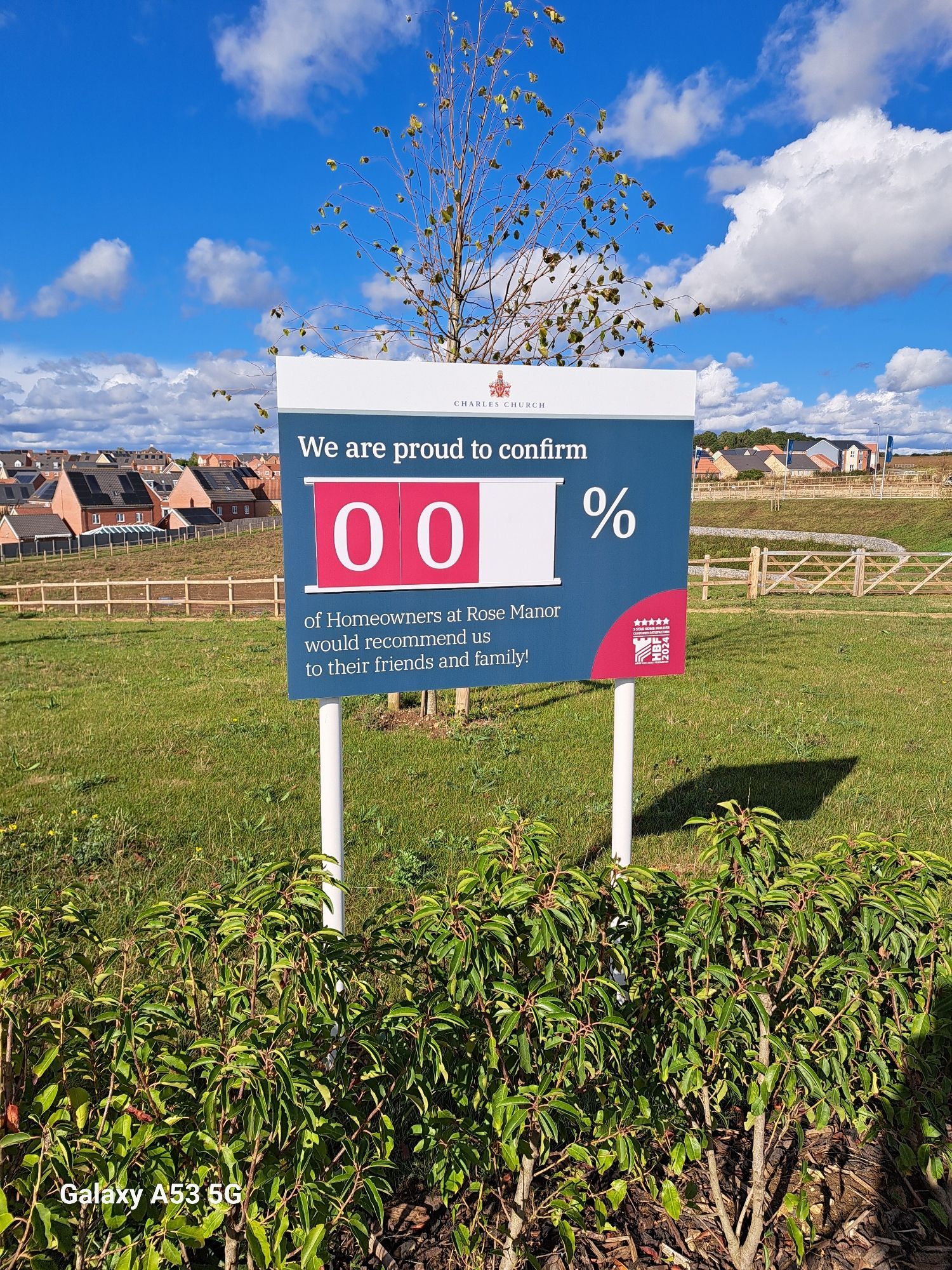 Billboard proclaiming that 00% of home owners are happy with their ne Persimmon/Charles Church new home.