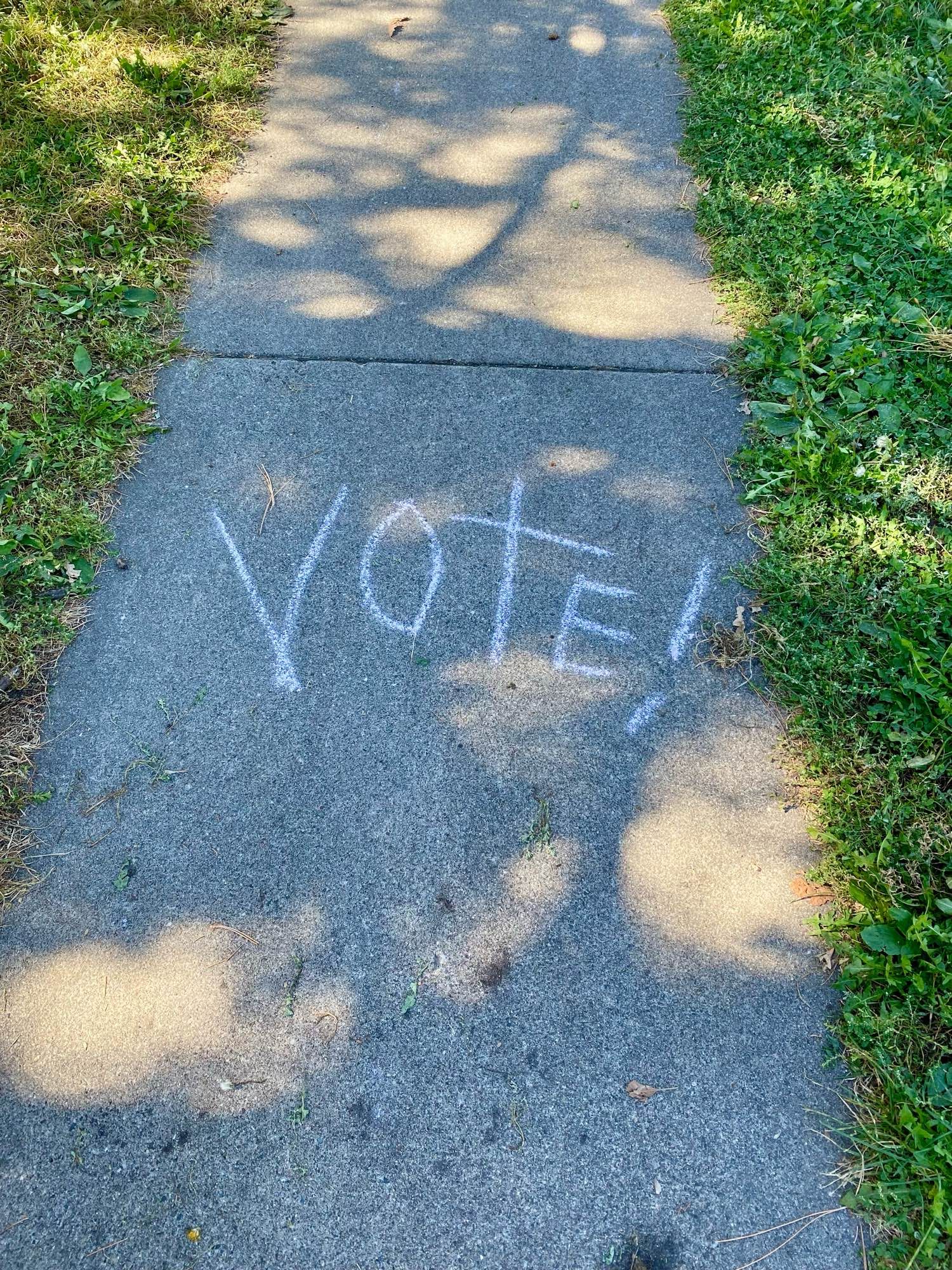 ‘Vote!’ Written in sidewalk chalk