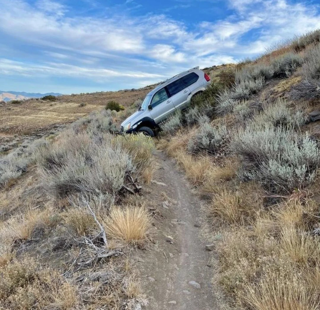 one of those dumb useless crossover SUV's blocking a mountain bike trail somewhere in a steppe environs