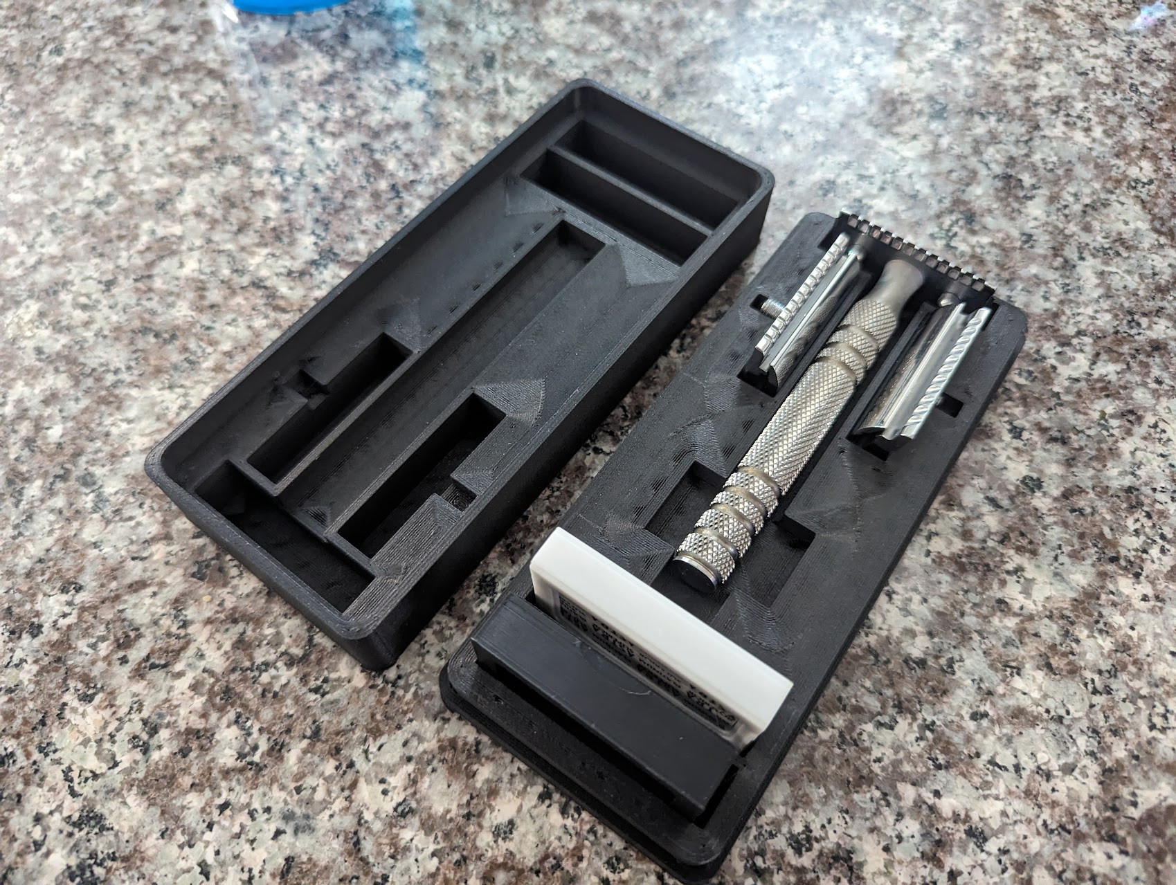 Picture of a shaving gear travel case populated with a safety razor and some other accessories.