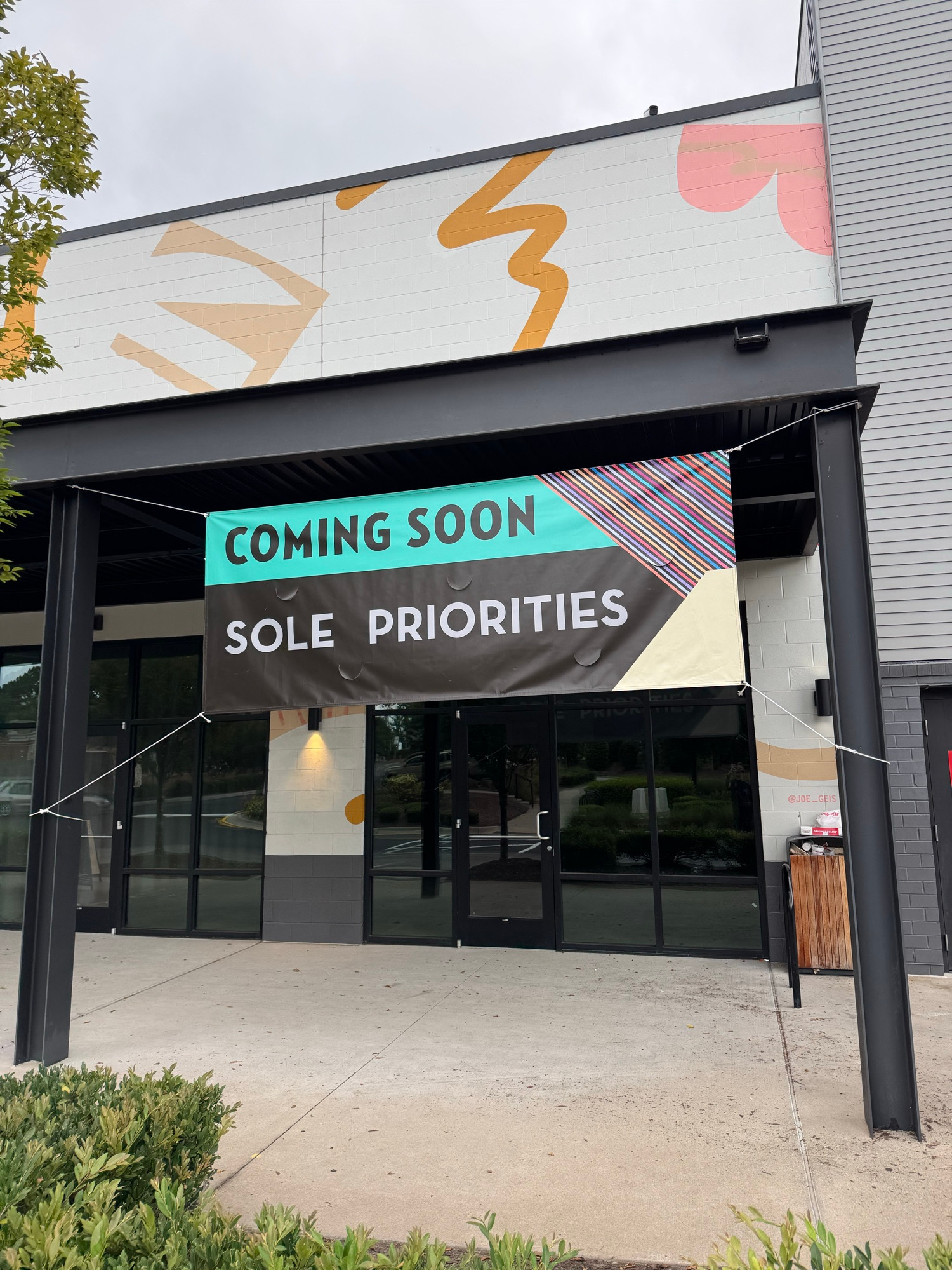 Storefront with a banner above it reading “coming soon sole priorities”