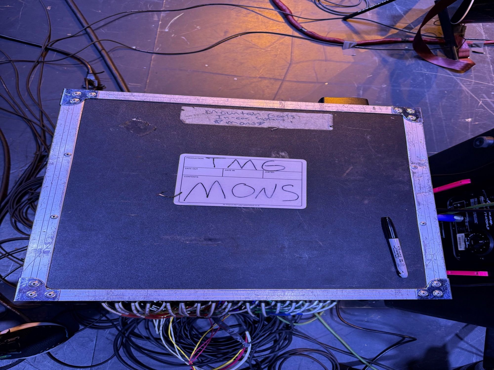 A road case with a sharpie on it and a sticker reading “tMG mons” which actually just means it’s for the monitors, but the joke of the post is that it is actually the band’s mons pubis