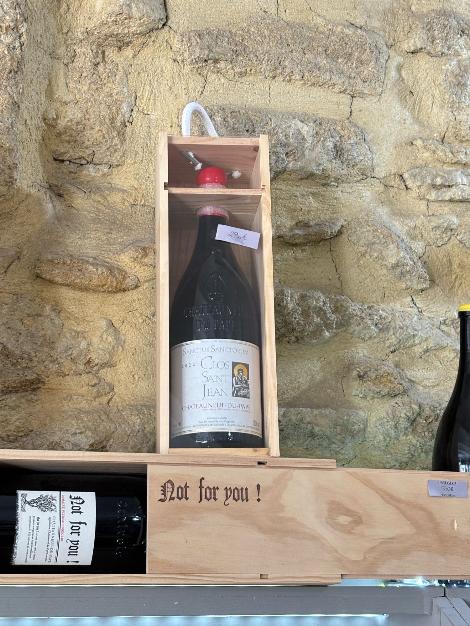 Wine bottle in wood box. White label says "Not for you" from Domaine Pierre Useguo price=550 €. Note: I did not buy this one.