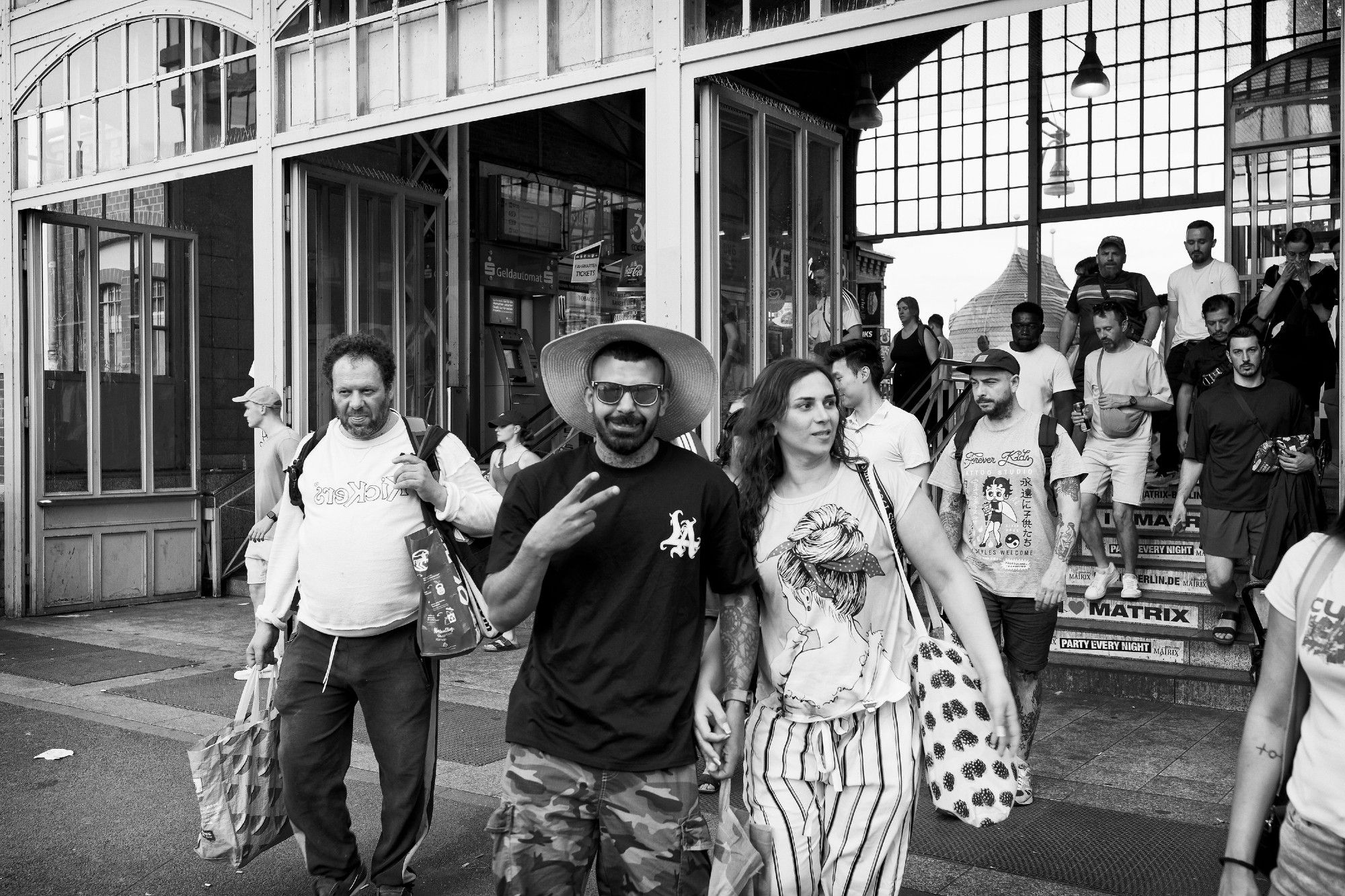 People are exiting the Warschauer Straße underground station and heading towards the street.