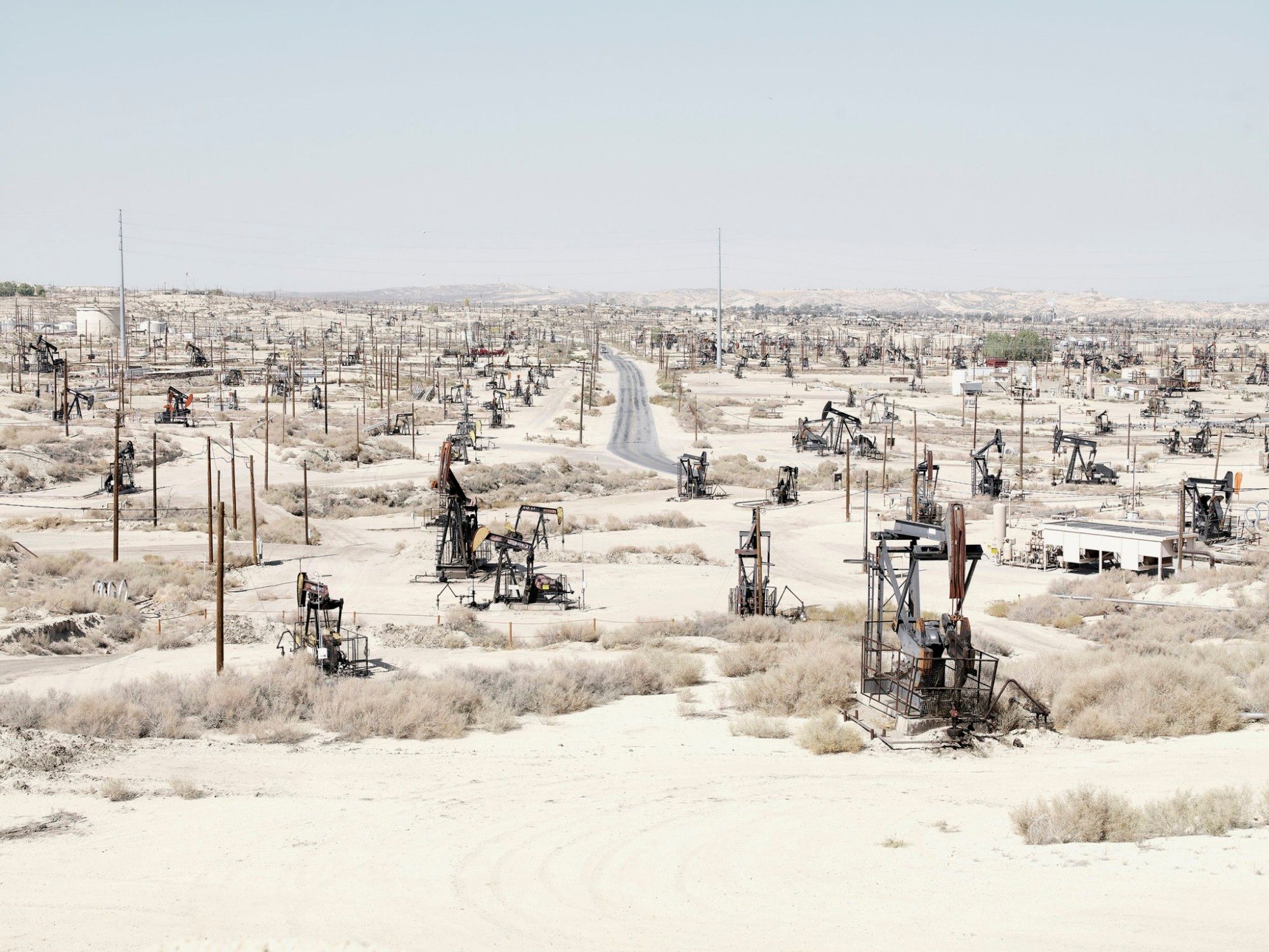 Photograph of a desert landscape strewn with pumps