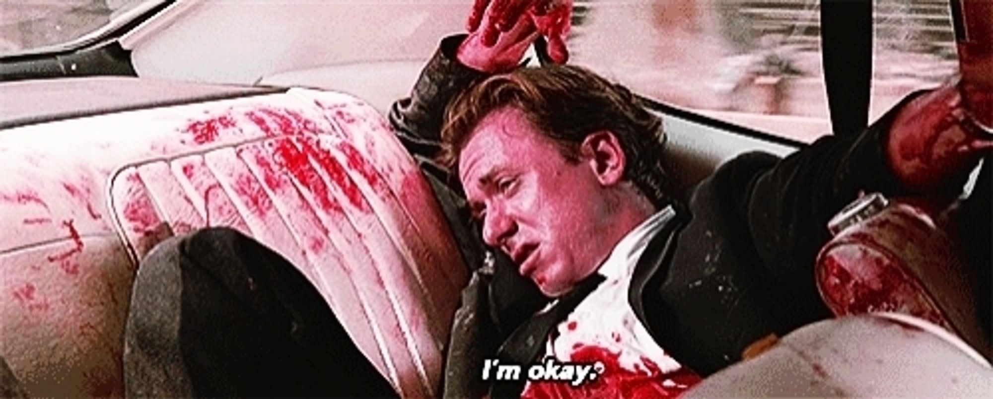 Reservoir Dogs still
Mr. Orange in the back of a car, covered in blood, saying "I'm OK."