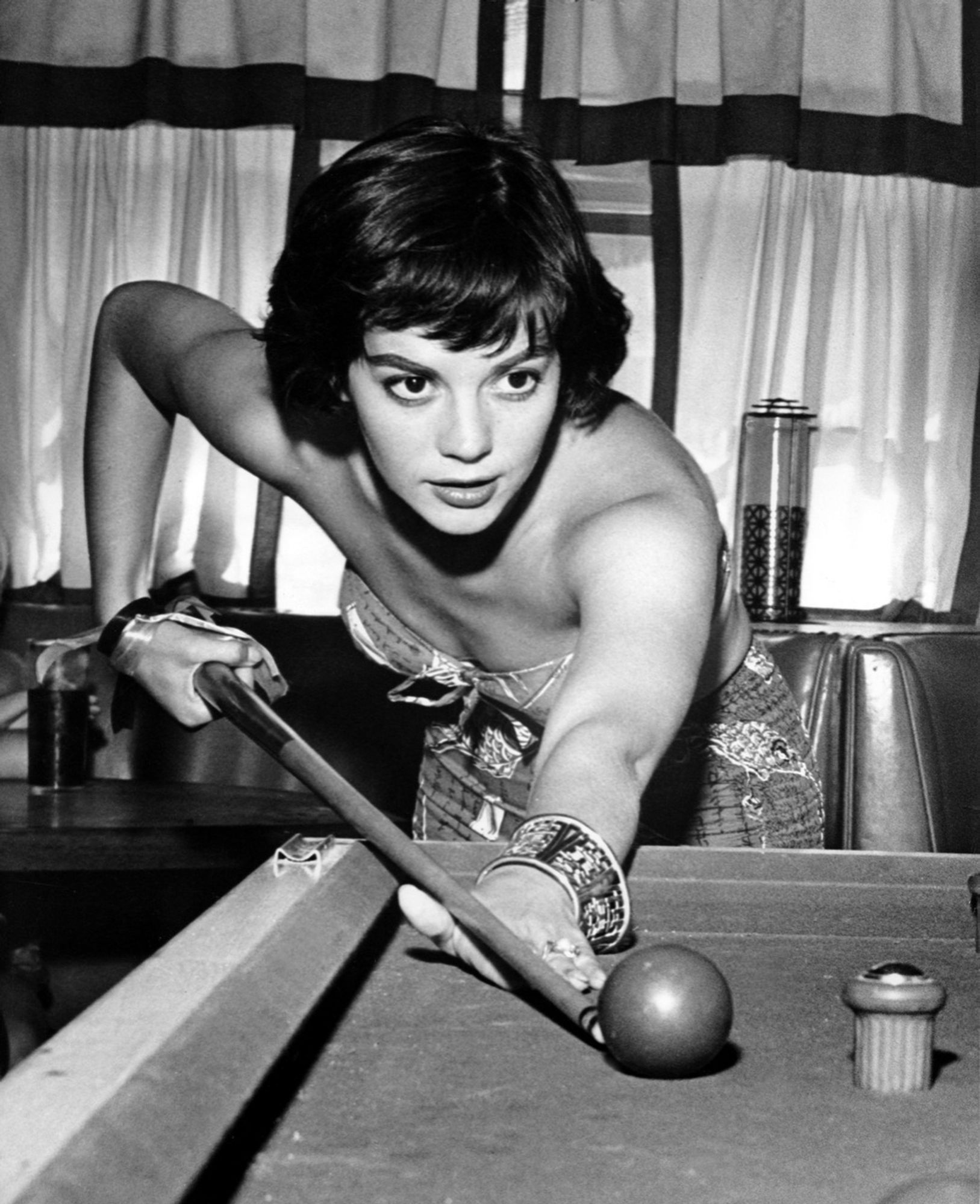 Black and white photograph of the actress playing pool been down to take the shot big eyes intent on her Target