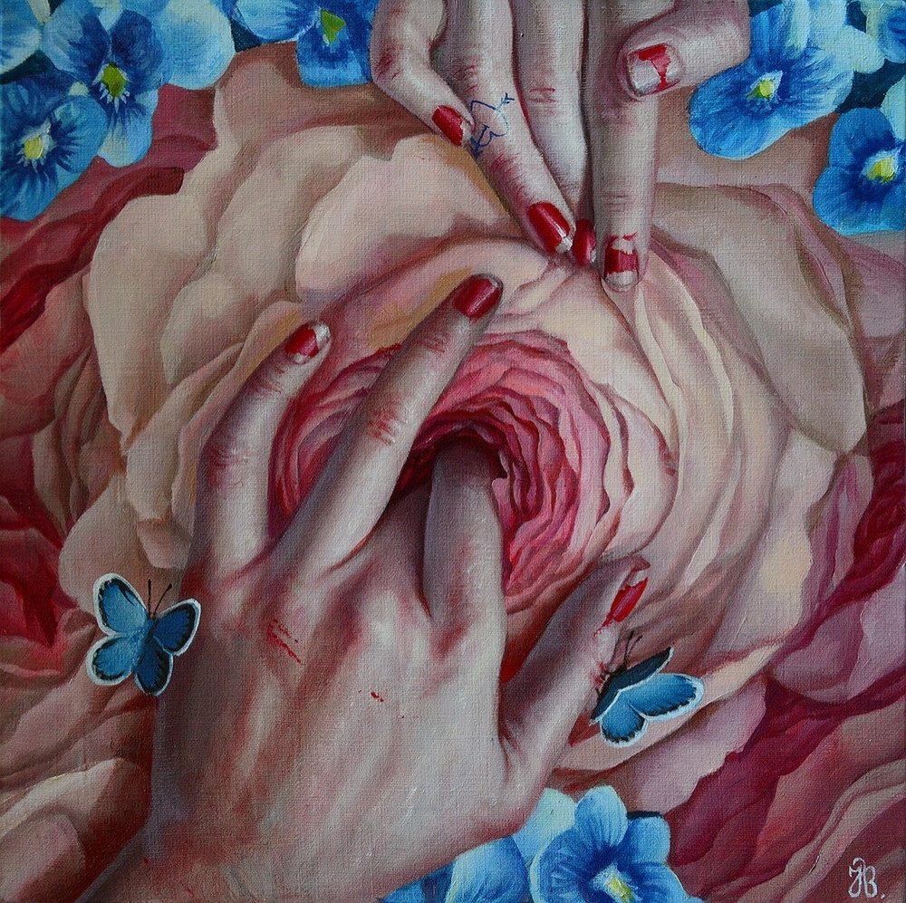 Women's hands feeling a flower