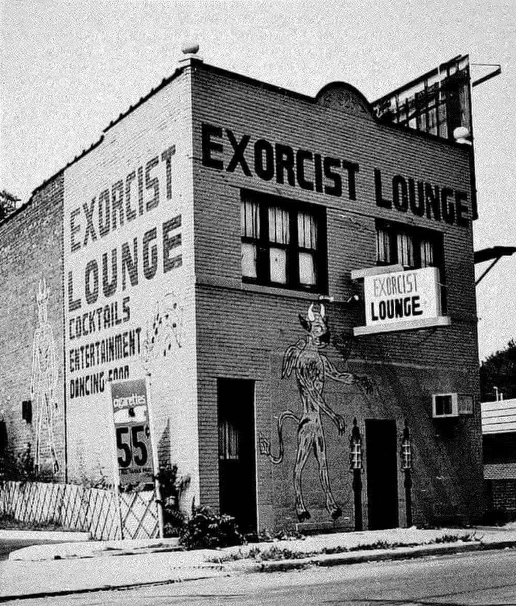 black & white photo of a dive-looking bar with EXORCIST LOUNGE on its signs. There's a painting of a devil on the front.

IDK the photographer