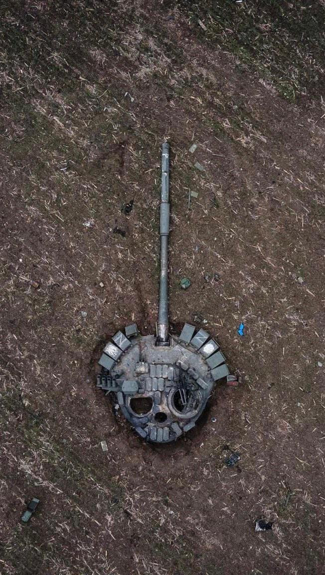 Destroyed tank turret from above with distinctive appearance of a human skull in its hatches and ERA blocks